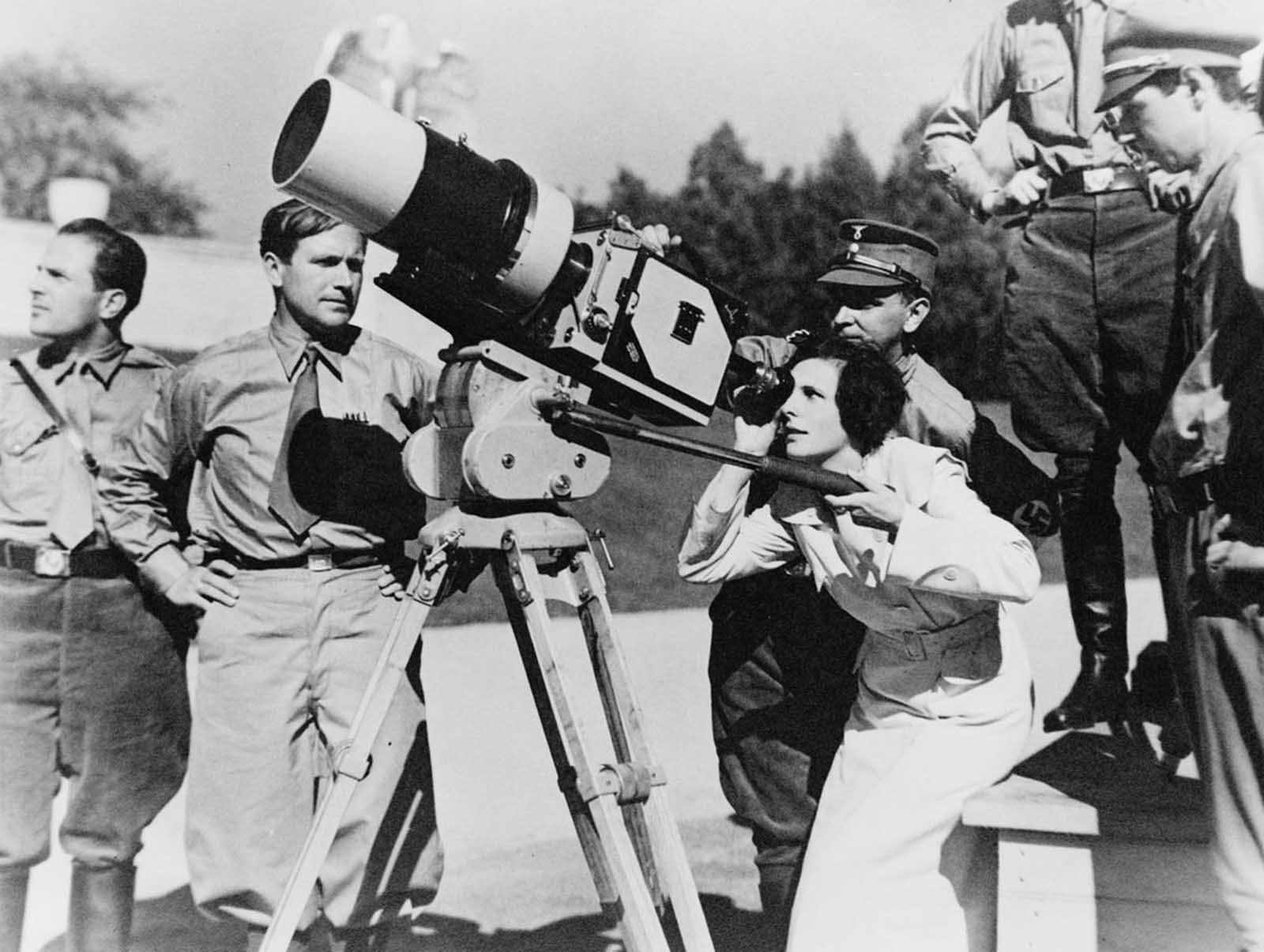 Filmmaker Leni Riefenstahl looks through the lens of a large camera prior to filming the 1934 Nuremberg Rally in Germany. The footage would be composed into the 1935 film