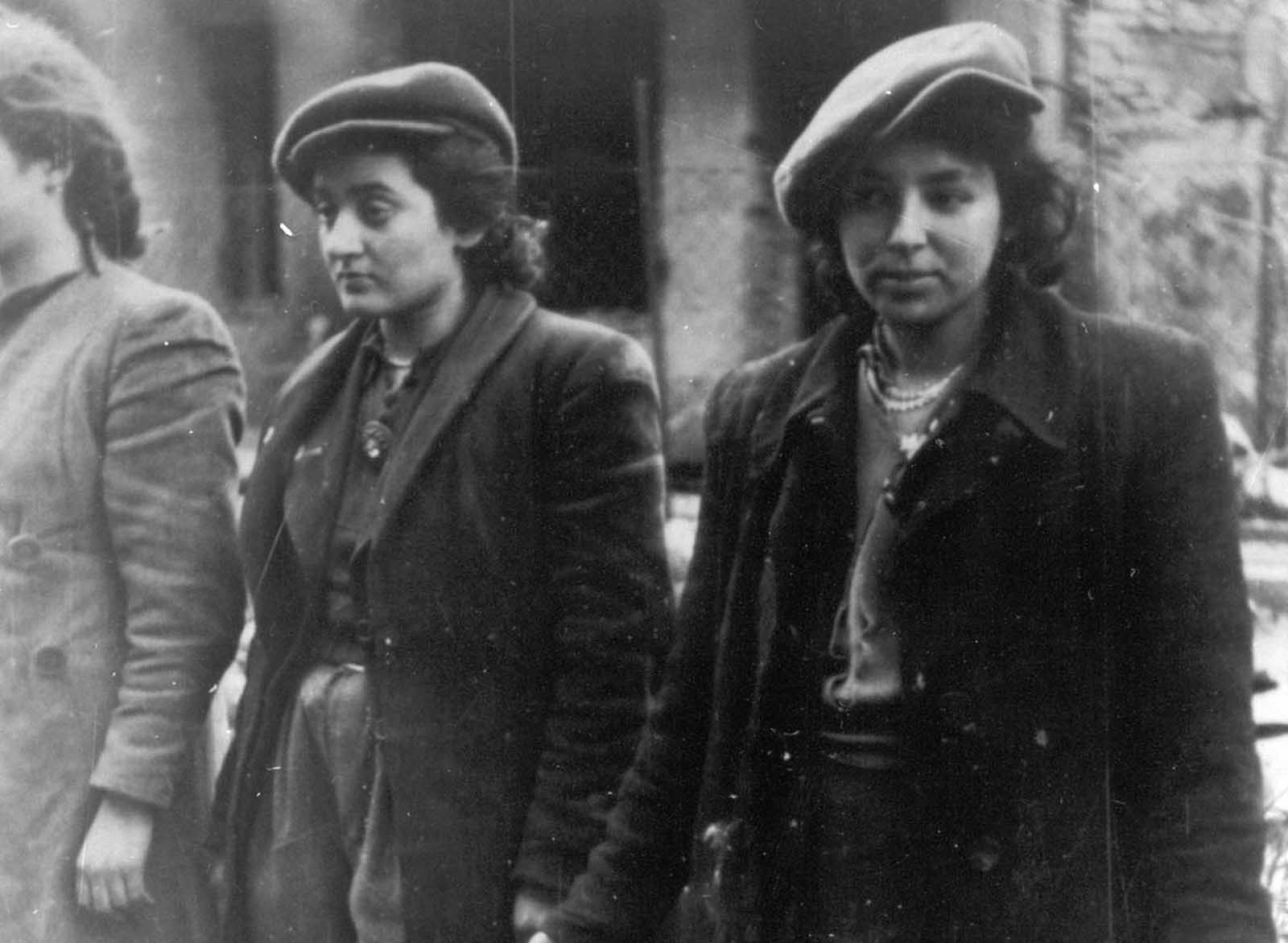A group of young Jewish resistance fighters are being held under arrest by German SS soldiers in April/May 1943, during the destruction of the Warsaw Ghetto by German troops after an uprising in the Jewish quarter.