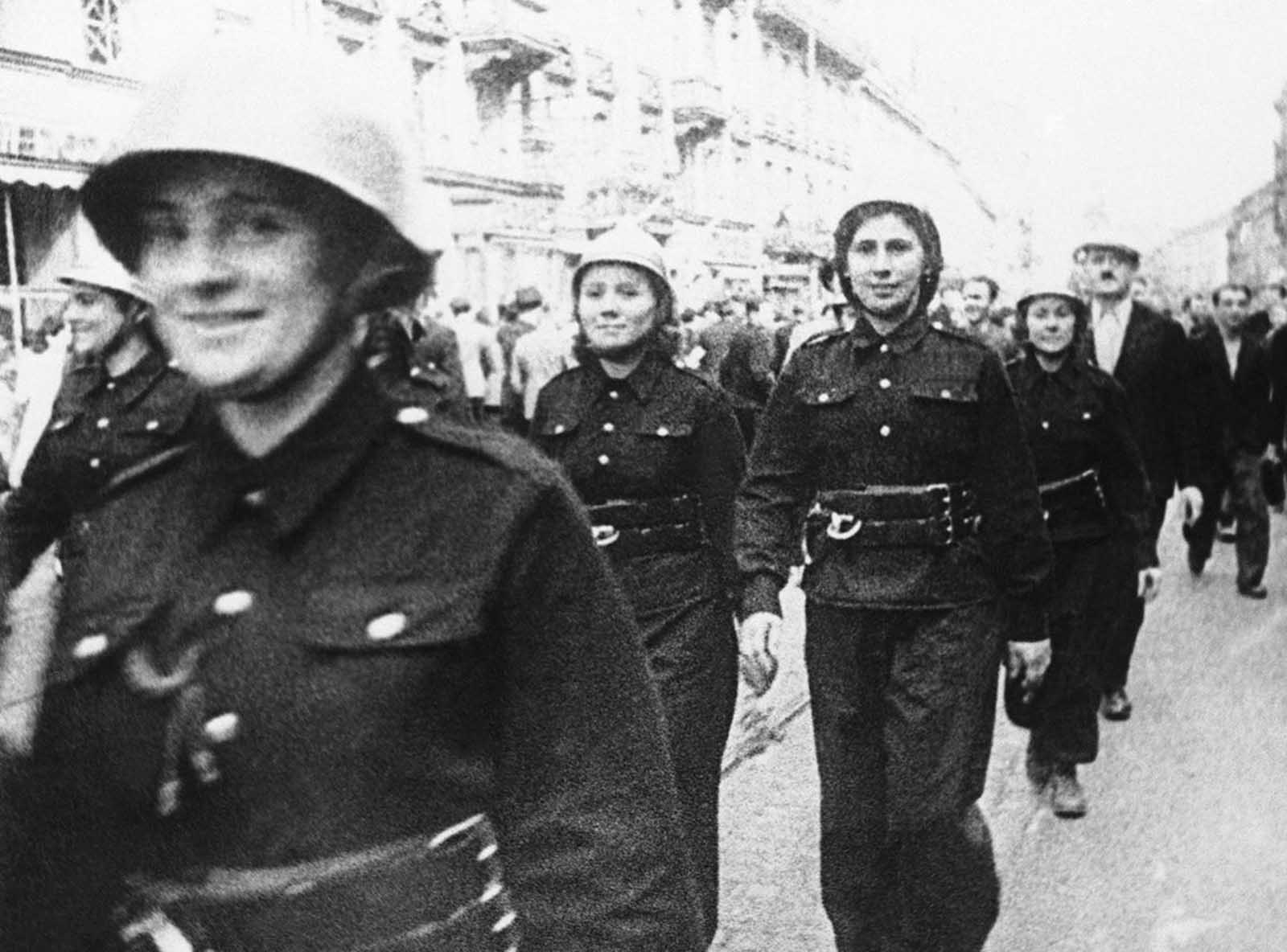 Steel-helmeted, uniformed Polish women march through the streets of Warsaw to aid in defense of their capital after German troops had started their invasion of Poland, on September 16, 1939.