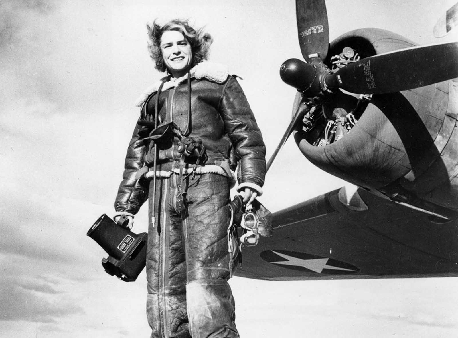 Life magazine photojournalist Margaret Bourke-White wears high-altitude flying gear in front of an Allied Flying Fortress airplane during a World War II assignment in February 1943.