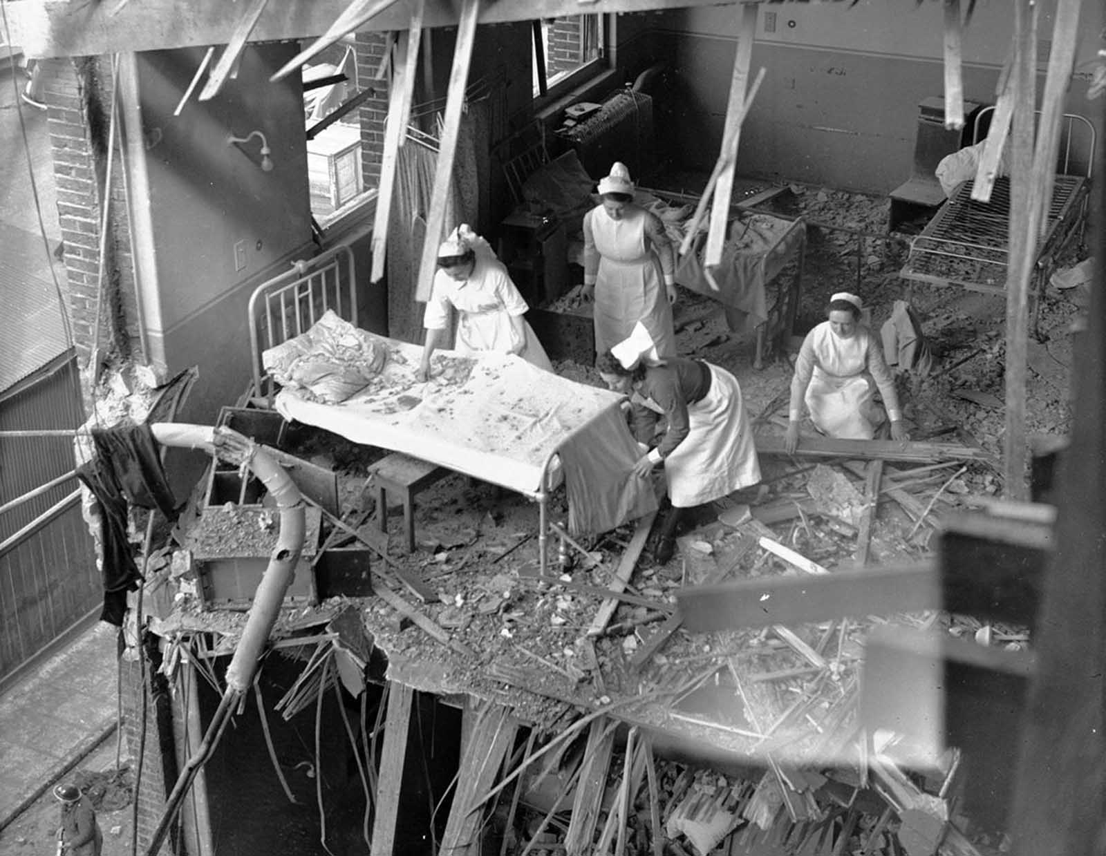 Nurses are seen clearing debris from one of the wards in St. Peter's Hospital, Stepney, East London, on April 19, 1941. Four hospitals were among the buildings hit by German bombs during a full scale attack on the British capital.