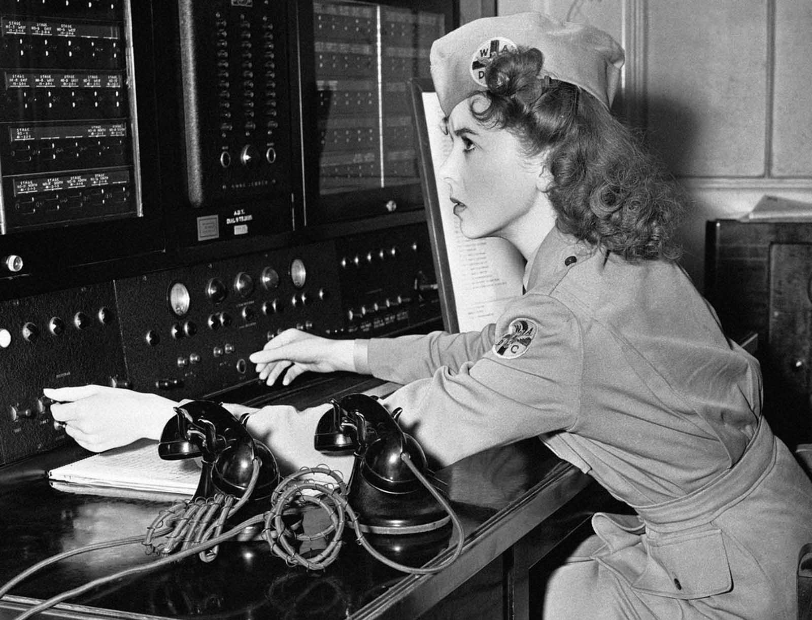 Movie actress Ida Lupino, is a lieutenant in the Women's Ambulance and Defense Corps and is shown at a telephone switch board in Brentwood, California, on January 3, 1942. In an emergency she can reach every ambulance post in the city. It is in her house and from here she can see the whole Los Angeles area.
