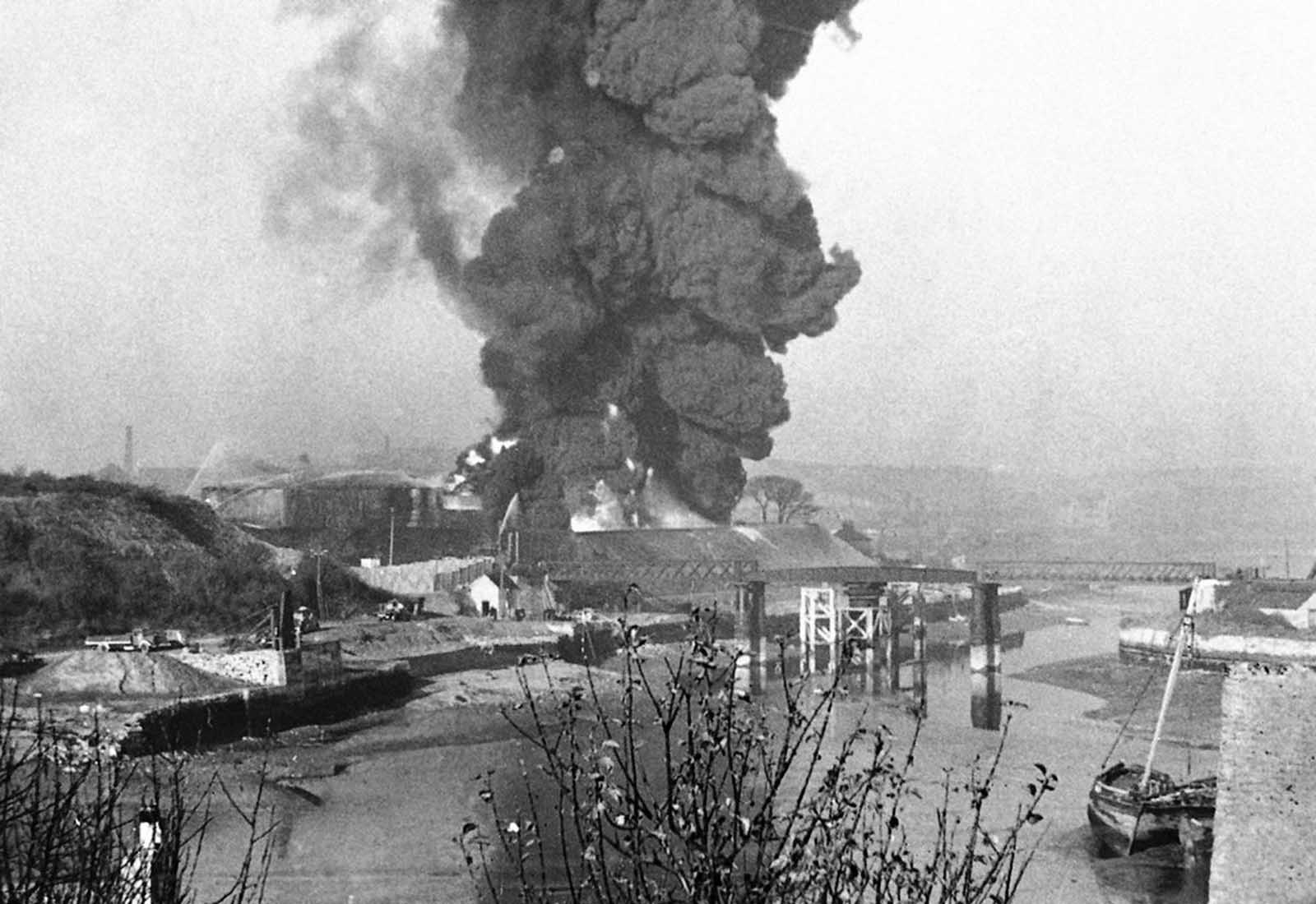 A great column of smoke billowing upward from a fire started at Plymouth, South West England, in November 1940, as a result of heavy enemy bombardment.