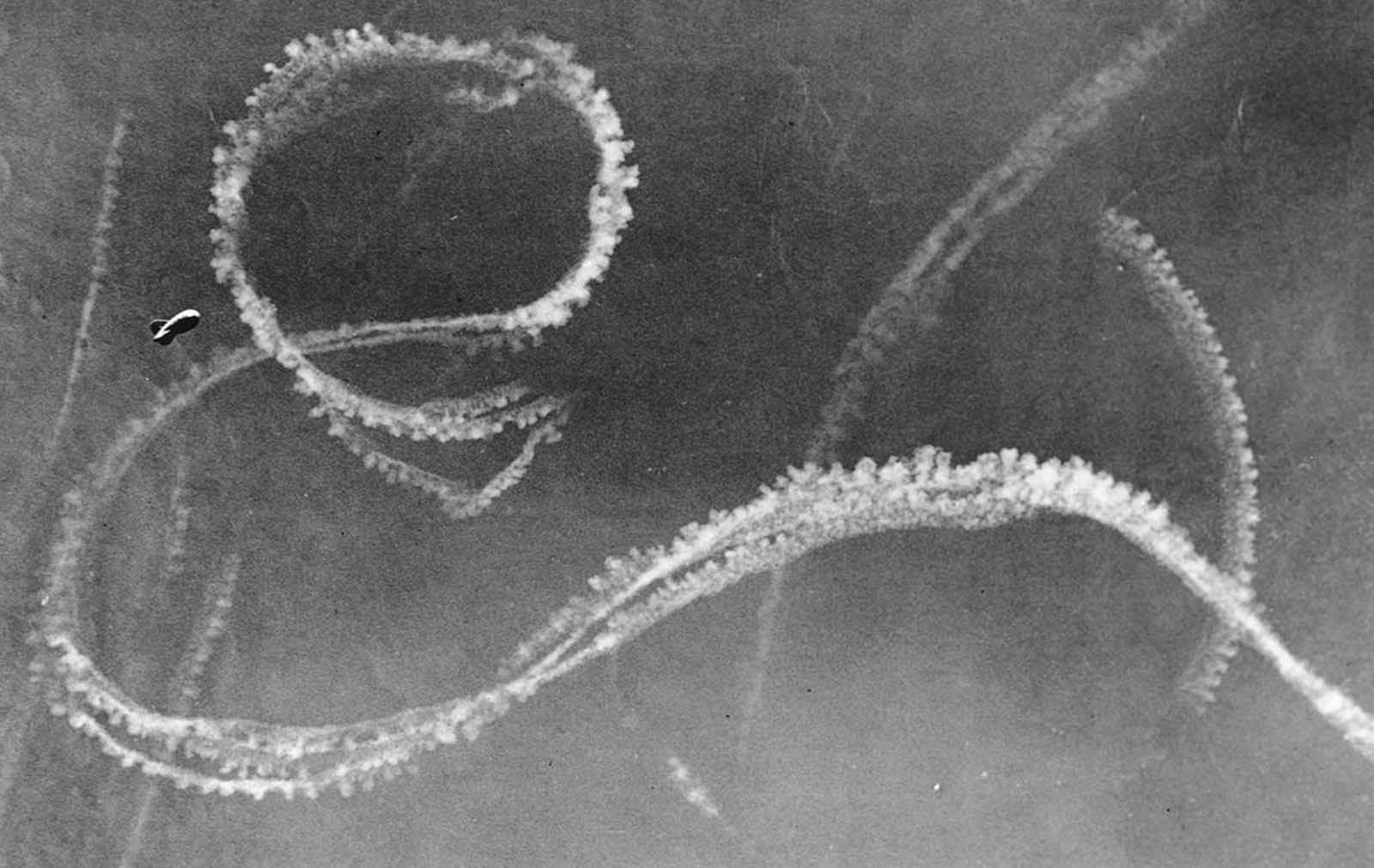 The condensation trails from German and British fighter planes engaged in an aerial battle appear in the sky over Kent, along the southeastern coast of England, on September 3, 1940.