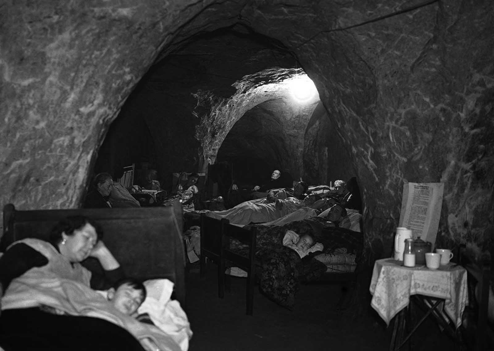 Hundreds of people, many of whom have lost their homes through bombing, now use the caves in Hastings, a south-east English town as their nightly refuge. Special sections are reserved for games and recreation, and several people have