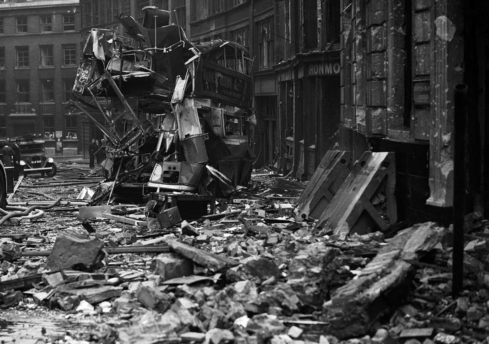 Air raid damage, including the twisted remains of a double-decker city bus, in the City of London on September 10, 1940.