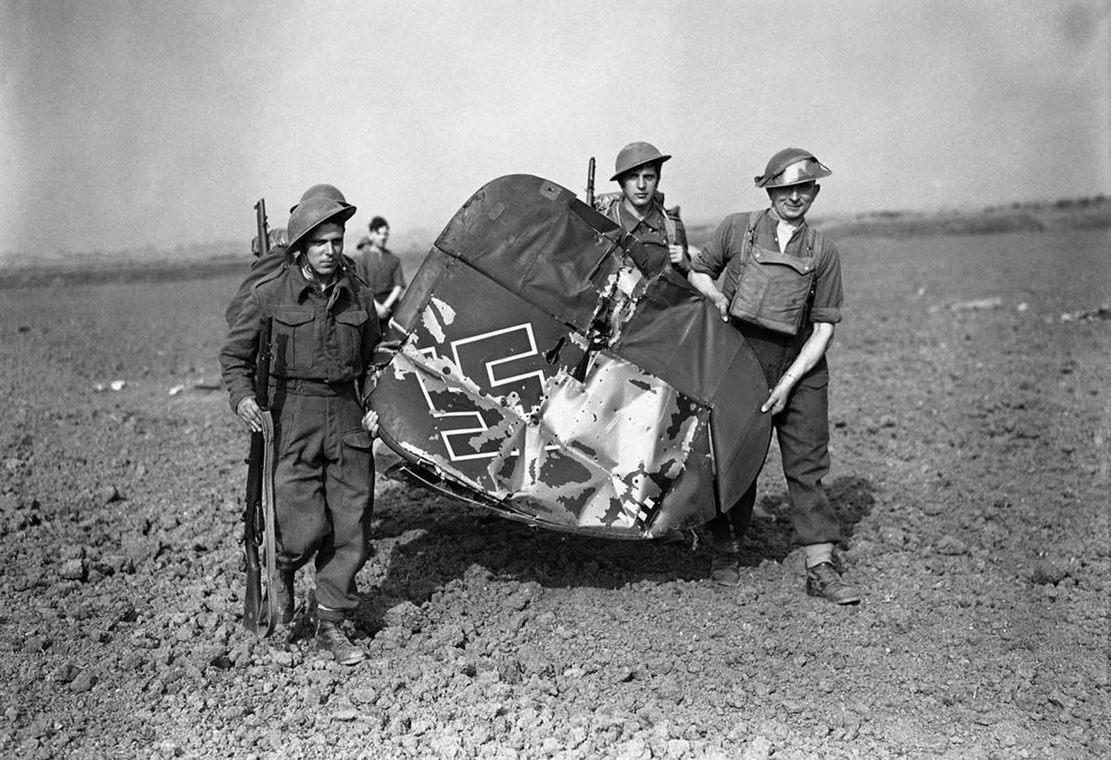 Soldiers carrying off the tail of a Messerschmitt 110, which was shot down by fighter planes in Essex, England, on September 3, 1940.