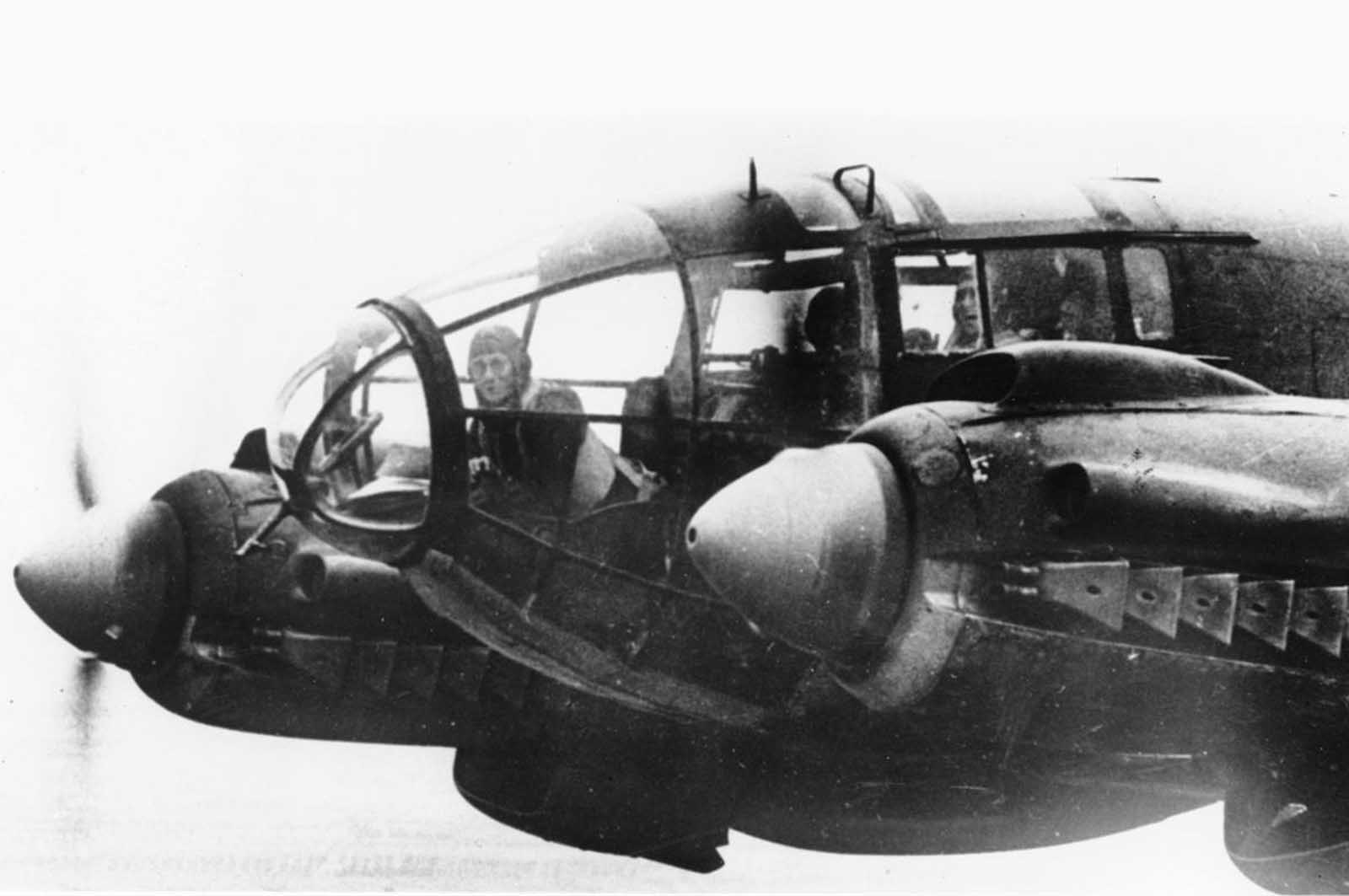 A forward machine gunner sits at his battle position in the nose of a German Heinkel He 111 bomber, while en route to England in November of 1940.