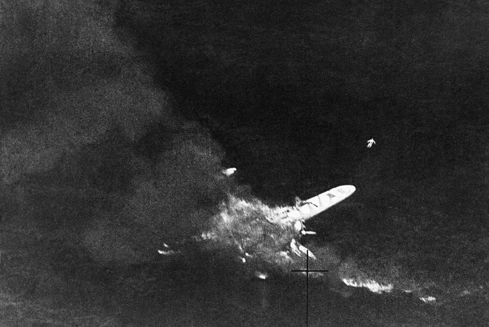 An Italian flying boat burning of the water off the coast of Tripoli, on August 18, 1941 after an encounter with a royal air force fighter patrol. Just above the tip of the port wing, the body of an Italian airman can be seen floating.