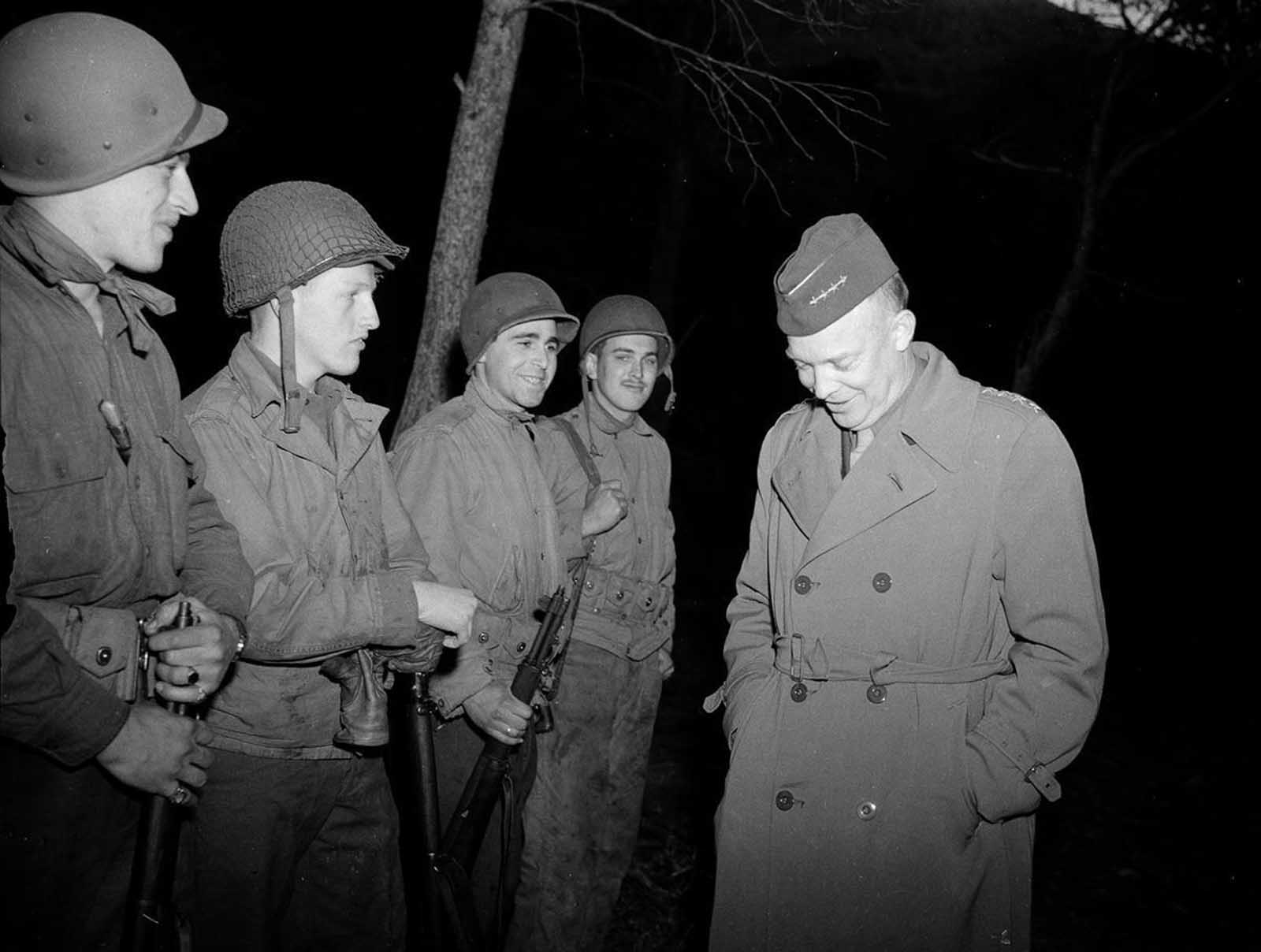 General Dwight D. Eisenhower, right, commander-in-chief in North Africa, jokes with four American soldiers during a recent inspection of the Tunisian battlefront, on March 18, 1943. 