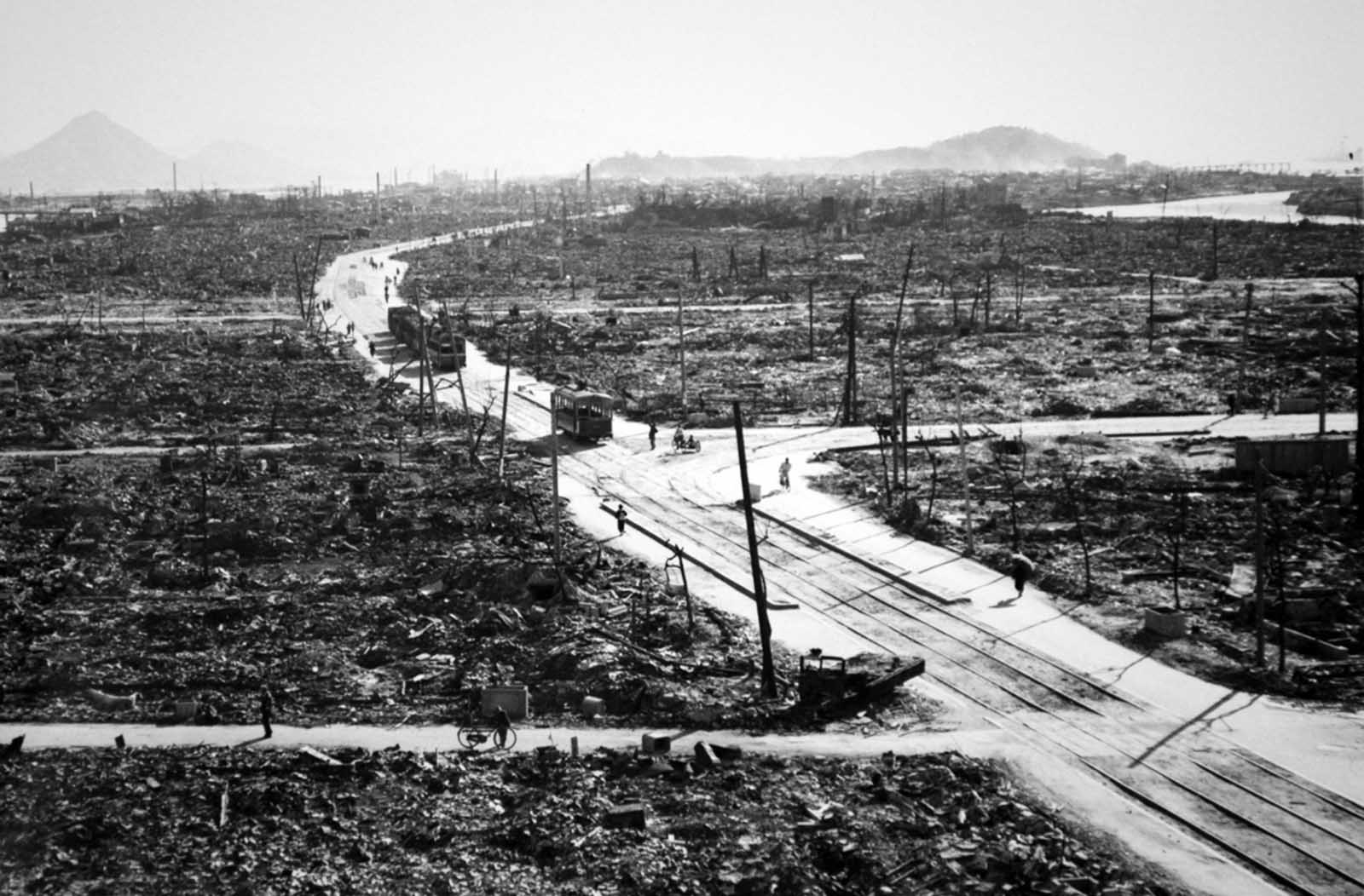 Streetcars, bicyclists, and pedestrians make their way through the wreckage of Hiroshima.