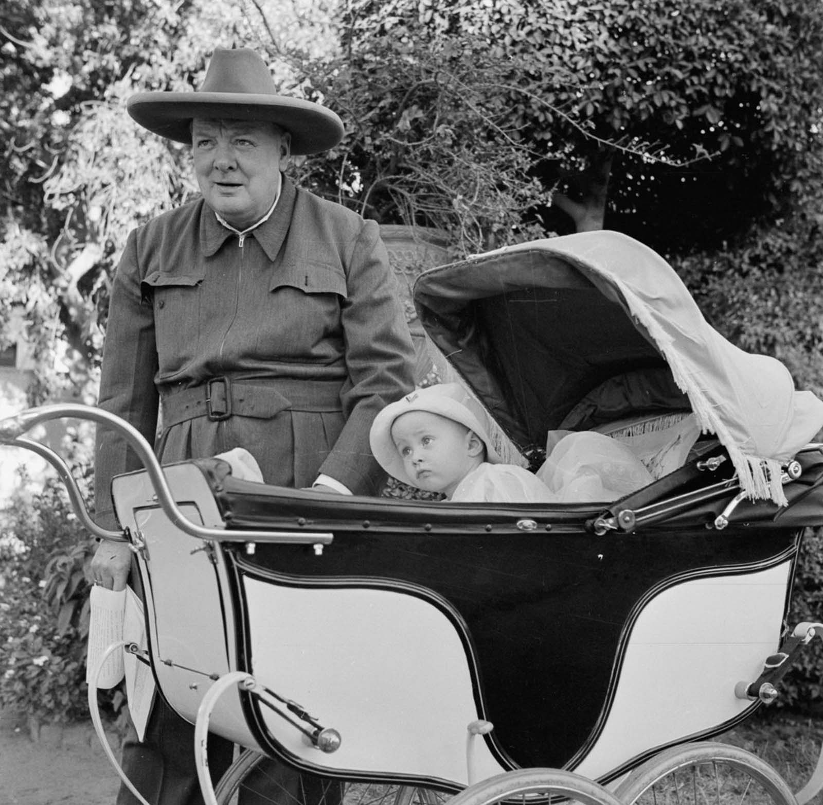 Winston Churchill with baby Victor Lampson. Churchill is wearing an all-in-one