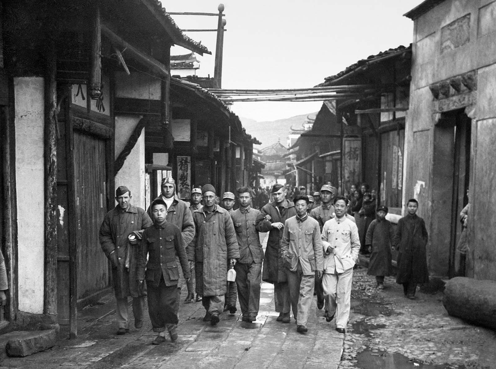 Four unidentified Doolittle Raid crewmen, who bailed out over China from Aircraft #14, are escorted in a Chinese village before being reunited with other airmen in April of 1942. Most of the crew members made it to China, either crash landing, or bailing out over land. The assistance given by the Chinese to the airmen spurred the Japanese Imperial Army to carry out a retaliatory action called the Zhejiang-Jiangxi Campaign -- over the course of four months, entire villages were destroyed, and an estimated 250,000 Chinese civilians were killed.