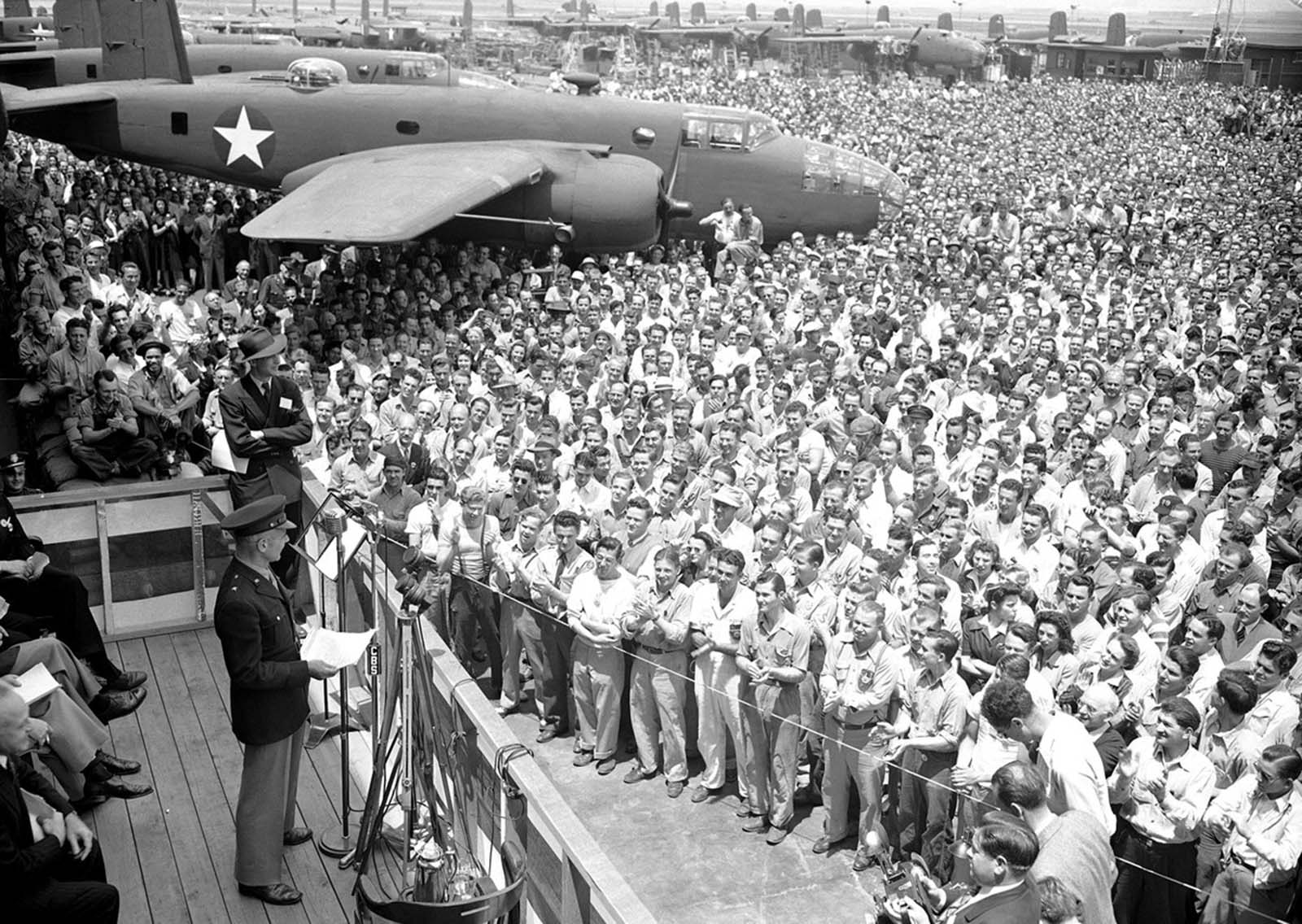 Lt. Col. James Doolittle, who led the April, 1942 air raid on Tokyo, addresses a throng of aircraft workers at the North American Aviation plant on June 1, 1942. He said that
