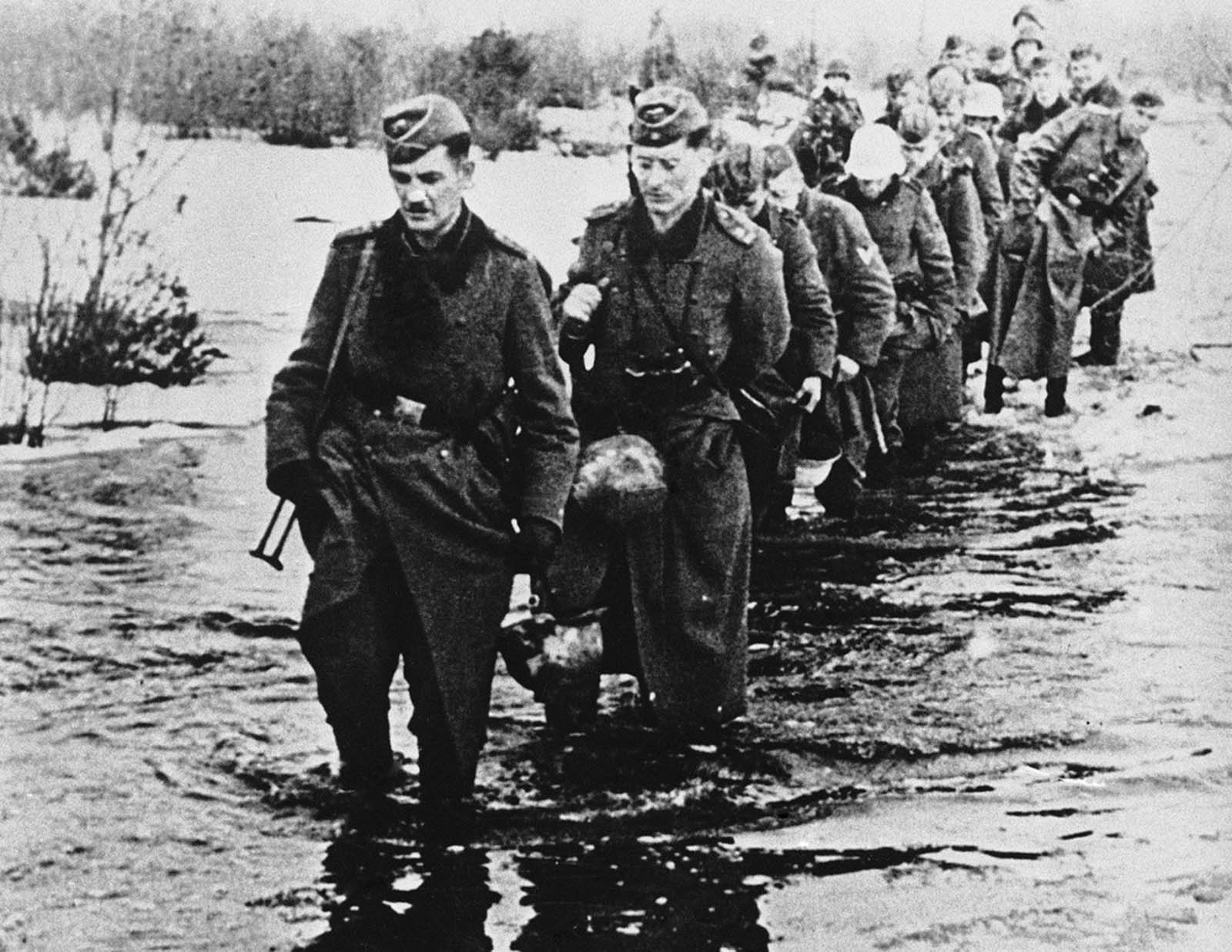 he appalling conditions ruling on the Russian front following the thaw when the winter snows melted and resulted in widespread floods on May 23, 1942. German soldiers wade through icy water which is knee deep, somewhere in Russia.