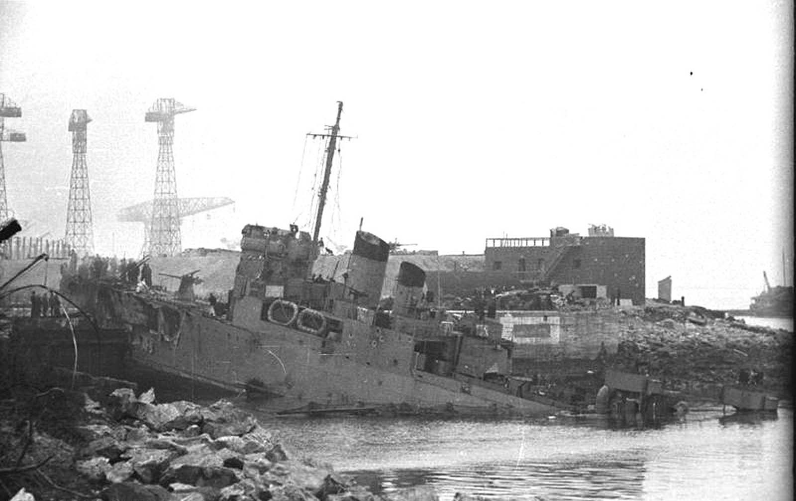 The British destroyer HMS Campbeltown sits destroyed, wedged into the dock gates of Normandie dry dock at St. Nazaire in German-occupied France, on March 28, 1942. Members of the Royal Navy and British Commandos carried out an amphibious raid on the docks earlier that day, attempting to prevent the Germans from possessing such a valuable asset. The Campbeltown was packed with with delayed-action explosives, which later detonated, killing more than 300 Germans and knocking the dock out of commission.