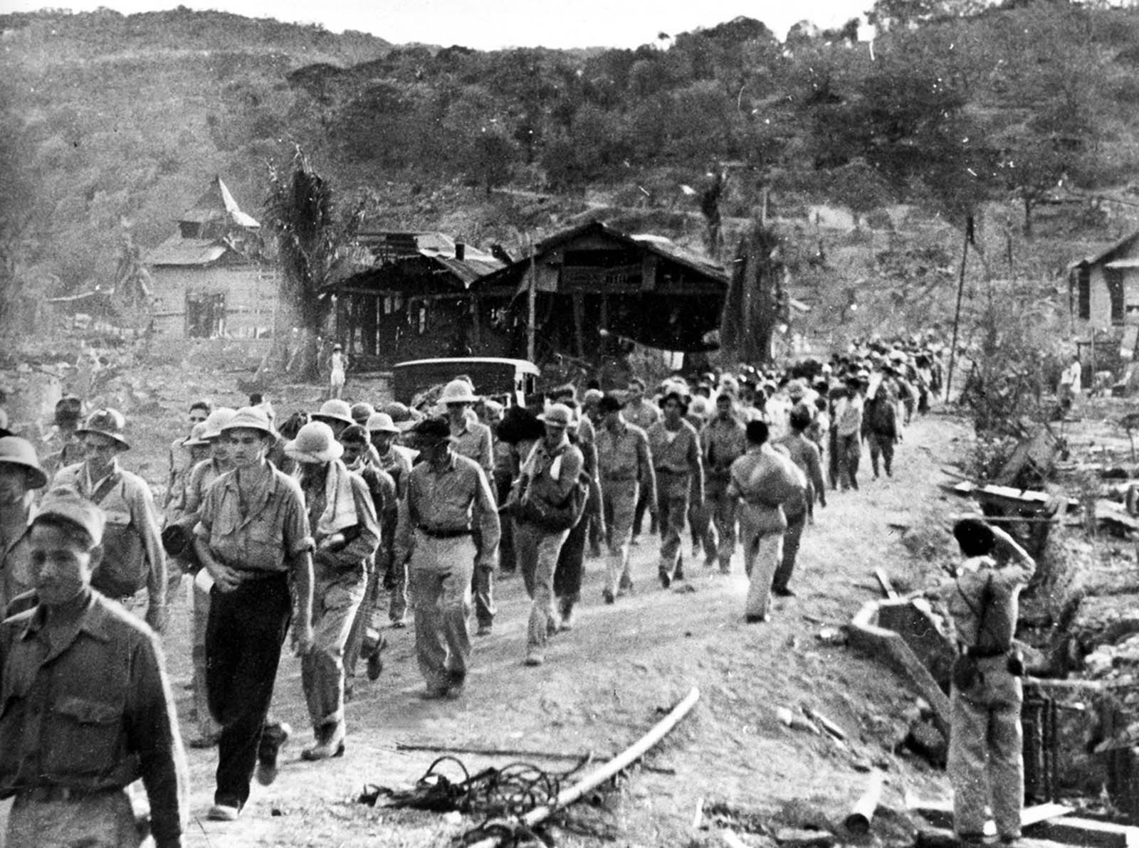 American and Filipino prisoners of war captured by the Japanese are shown at the start of the Death March after the surrender of Bataan on April 9, 1942, near Mariveles in the Philippines. Starting from Mariveles on April 10, some 75,000 American and Filipino prisoners of war were force-marched to Camp O'Donnell, a new prison camp 65 miles away. The prisoners, weakened after a three-month siege, were harassed by Japanese troops for days as they marched, the slow or sick killed with bayonets or swords.