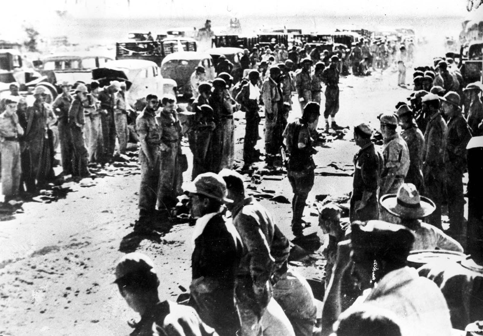 American soldiers line up as they surrender their arms to the Japanese at the naval base of Mariveles on Bataan Peninsula in the Philippines in April of 1942.