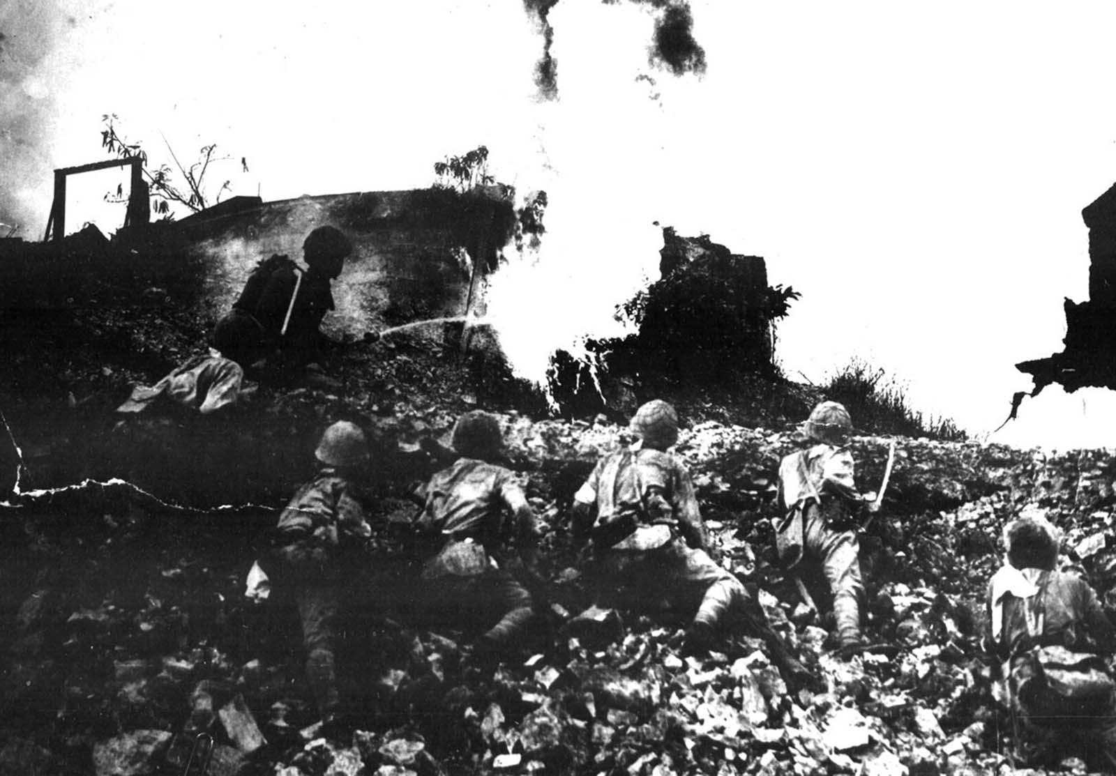 Japanese forces use flame-throwers while attacking a fortified emplacement on Corregidor Island, in the Philippines in May of 1942.