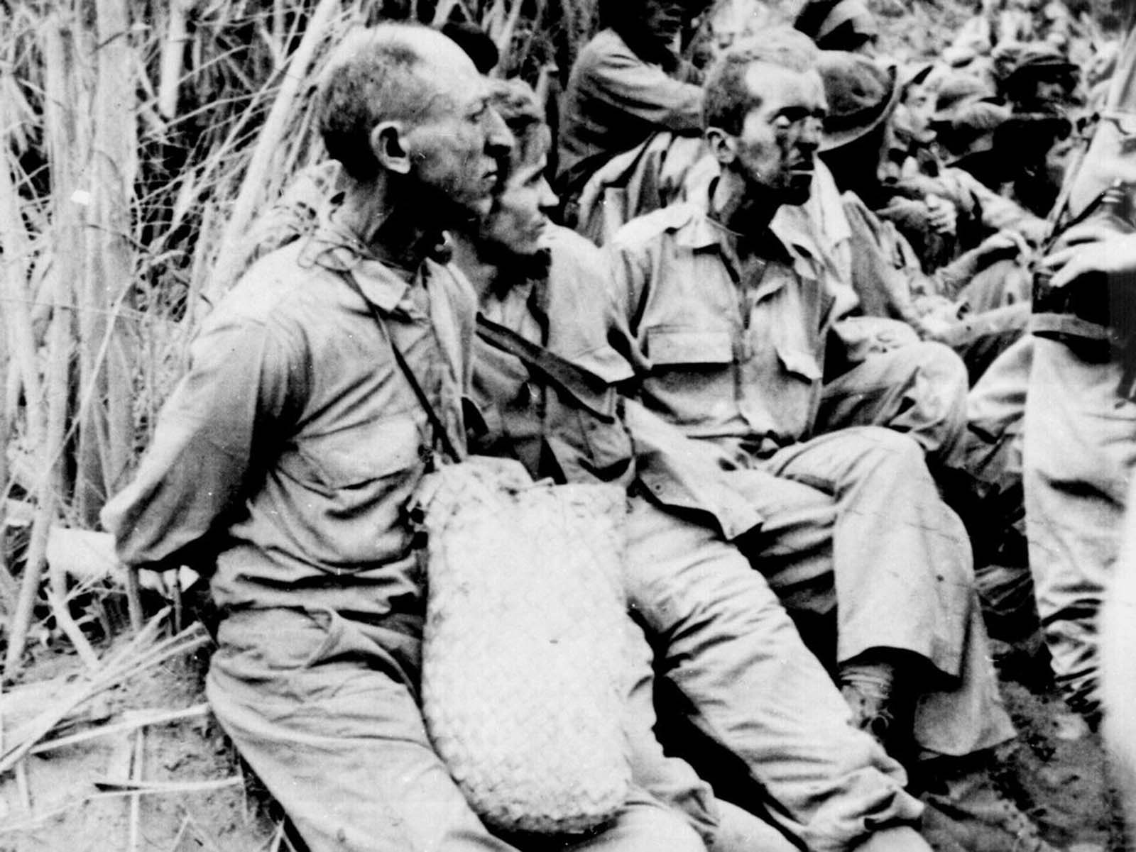 These prisoners were photographed along the Bataan Death March in April of 1942. They have their hands tied behind their backs. The estimates of the number of deaths that occurred along the march vary quite a bit, but some 5,000 to 10,000 Filipino and 600 to 650 American prisoners of war died before they could reach Camp O'Donnell. Thousands more would die in poor conditions at the camp in the following weeks.