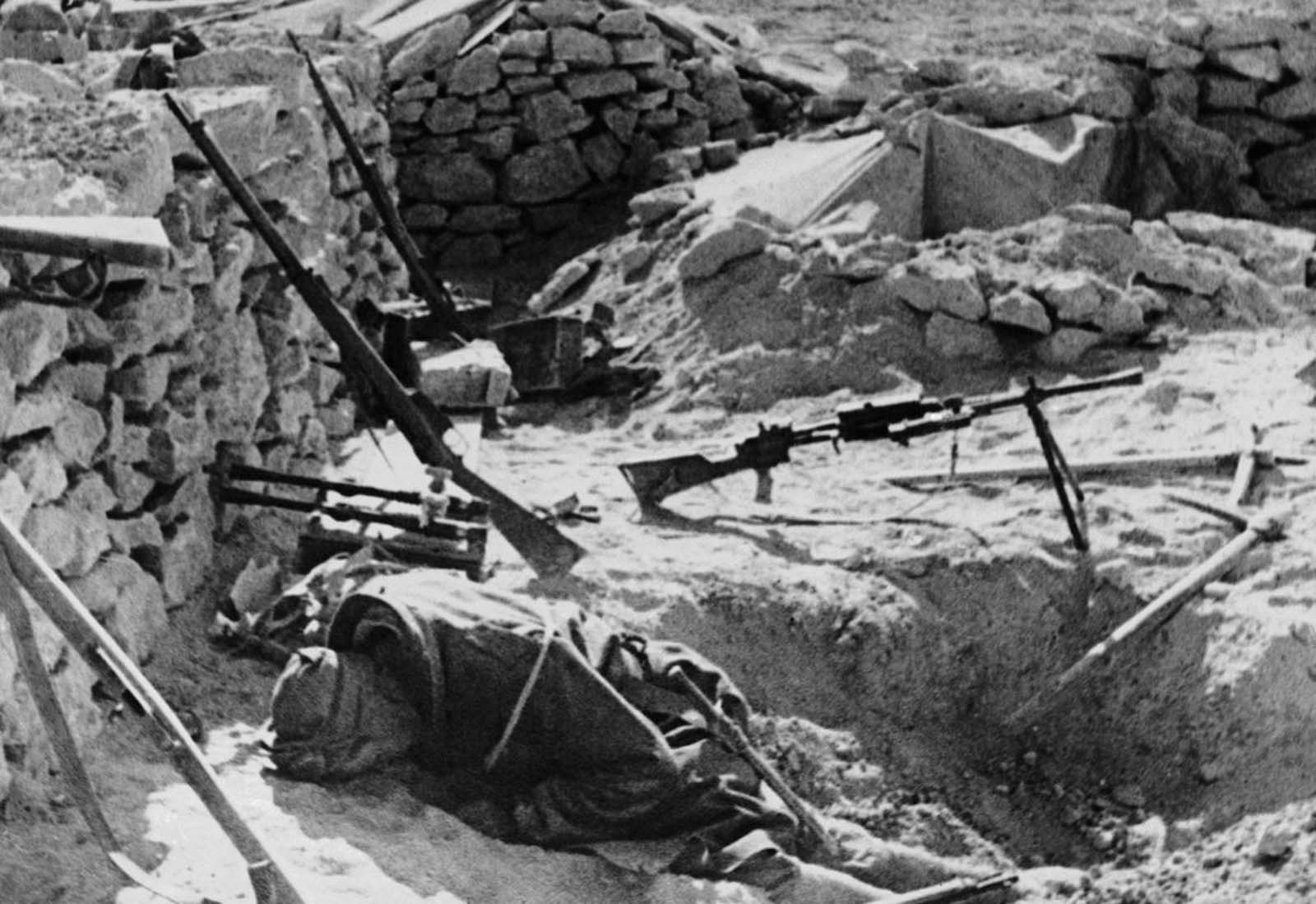 The body of an Italian soldier lies where he fell during battle, in a stone-walled fort somewhere in the West Libyan desert, on Febrary 11, 1941.