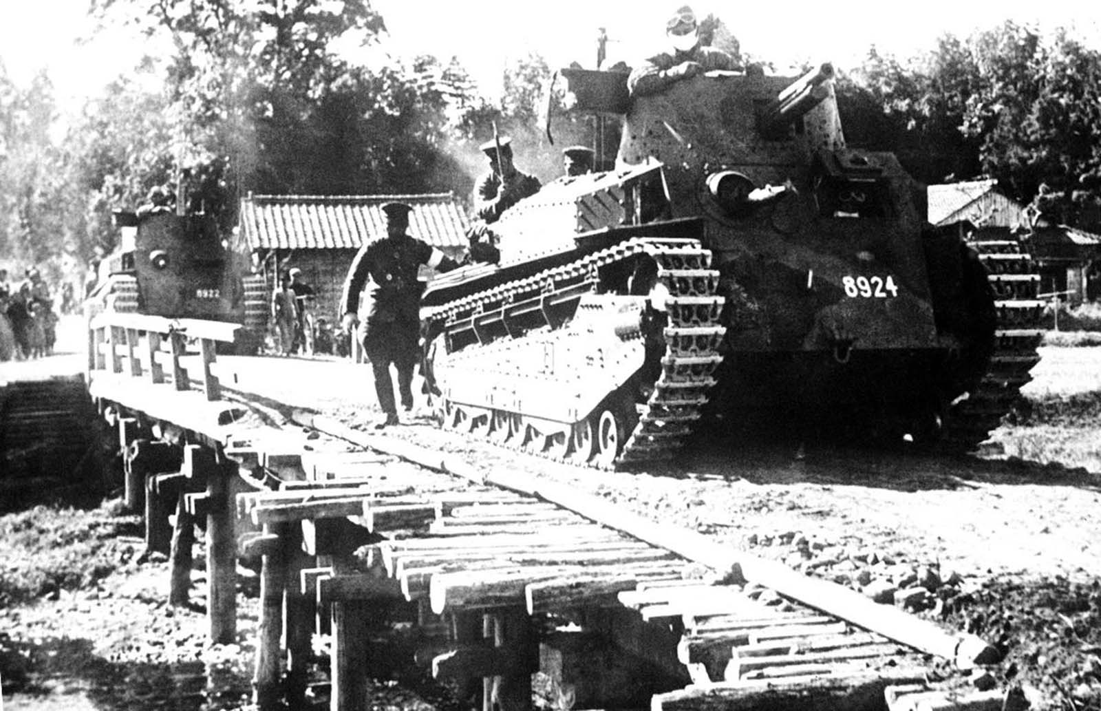 A Japanese tank passes over an emergency bridge, somewhere in China, on June 30, 1941.