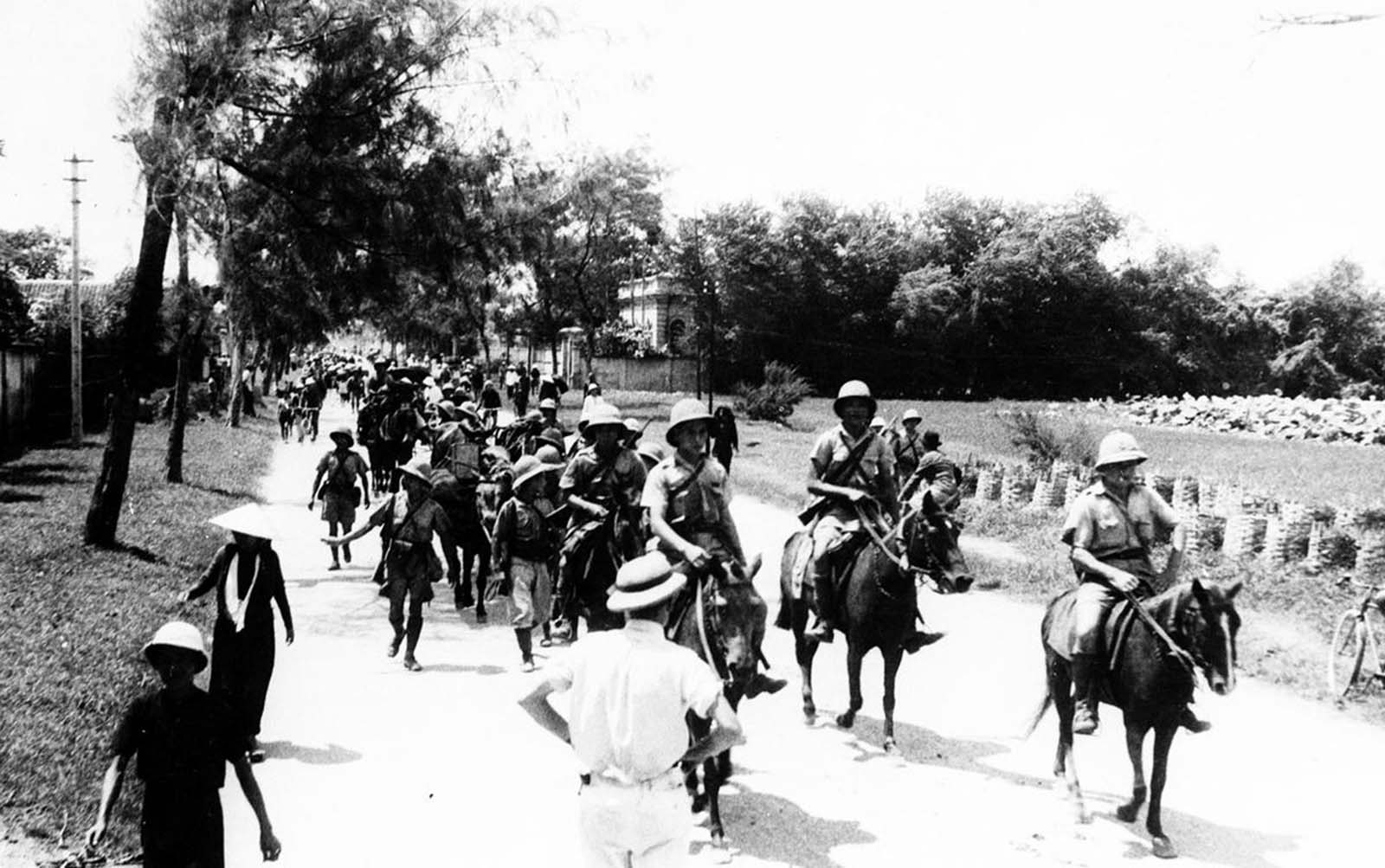 French colonial forces move out of Haiphong, in the Tonkin region of French Indochina, on September 26, 1940, as Japanese occupational troops take over the port and city under the terms of the Franco-Japanese agreement, where Vichy France granted military access to Japanese forces.