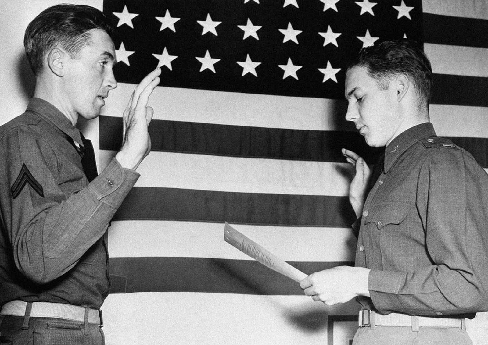 Jimmy Stewart, former movie star, is sworn in as a second lieutenant in the U.S. Air Corps by Lt. E.L. Reid, personnel officer of the west coast training center at Moffett Field, California, on January 1, 1941. Stewart was one of Hollywood's most popular actors before he was inducted into the Army in 1941.
