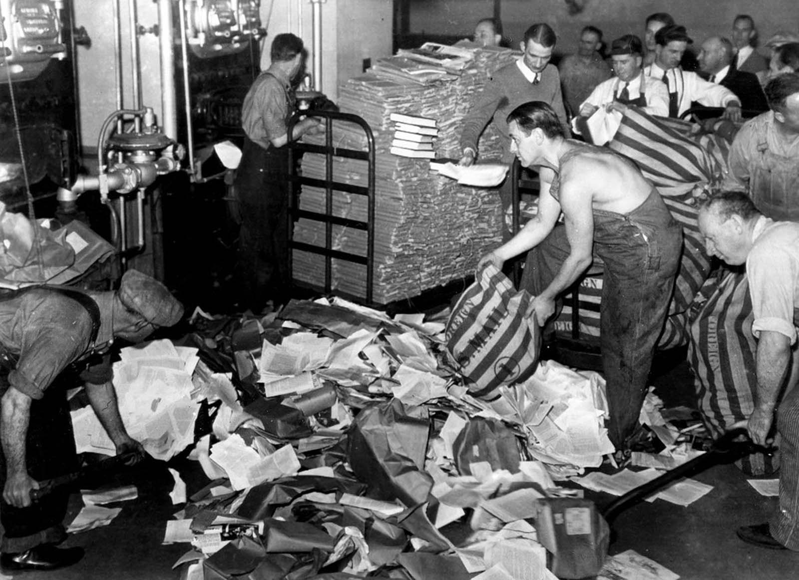 U.S. Postal employees feed 17 tons of reading matter, labeled by postal authorities as propaganda, into a furnace in San Francisco, California, on March 19, 1941. The bulk of the newspapers, books, and pamphlets came from Nazi Germany and some from Russia, Italy and Japan.