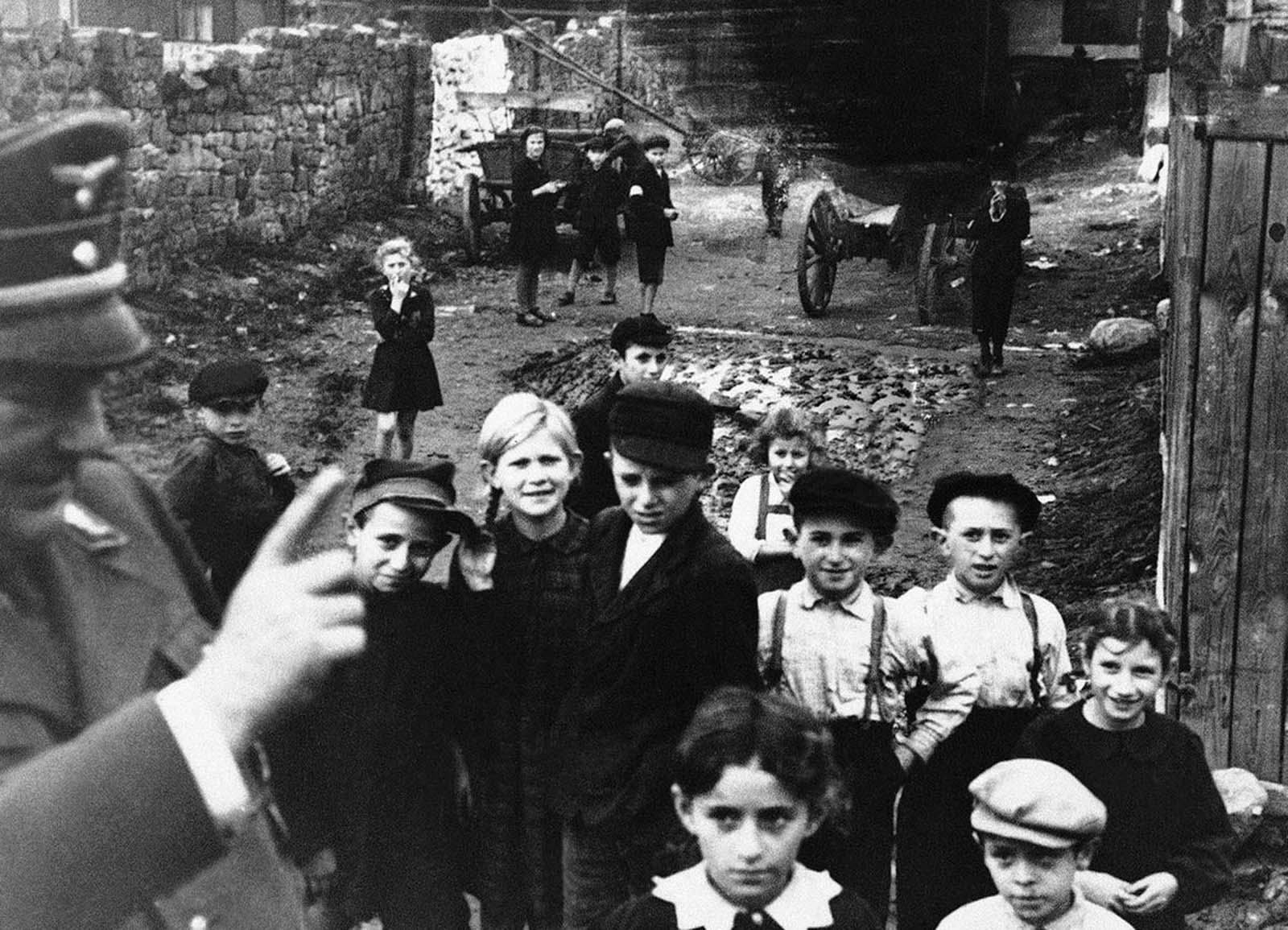 A German Army officer lecturers children in a ghetto in Lublin, German-occupied Poland, on December 1940, telling them