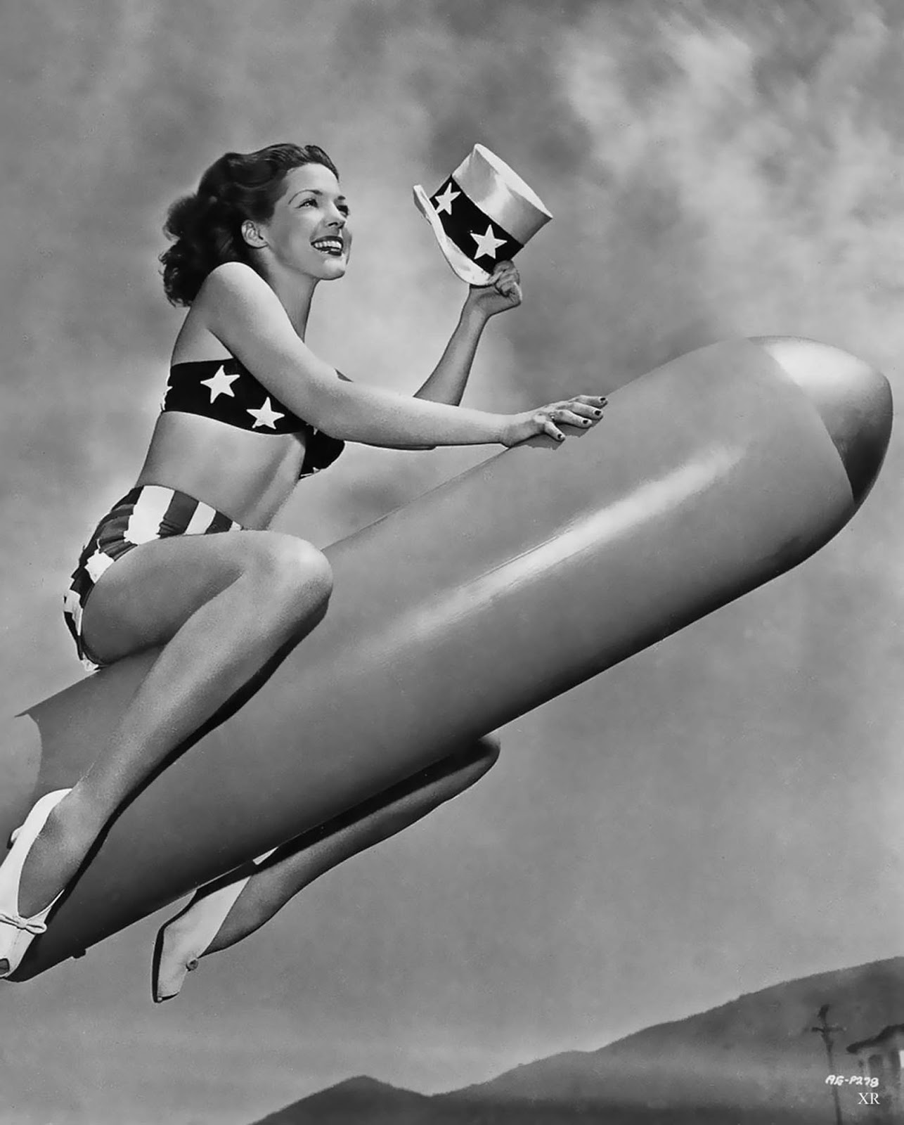 We don't know why this shot was taken, and why this pretty girl is riding a torpedo. However, it's from 1944 and, well... we like it.