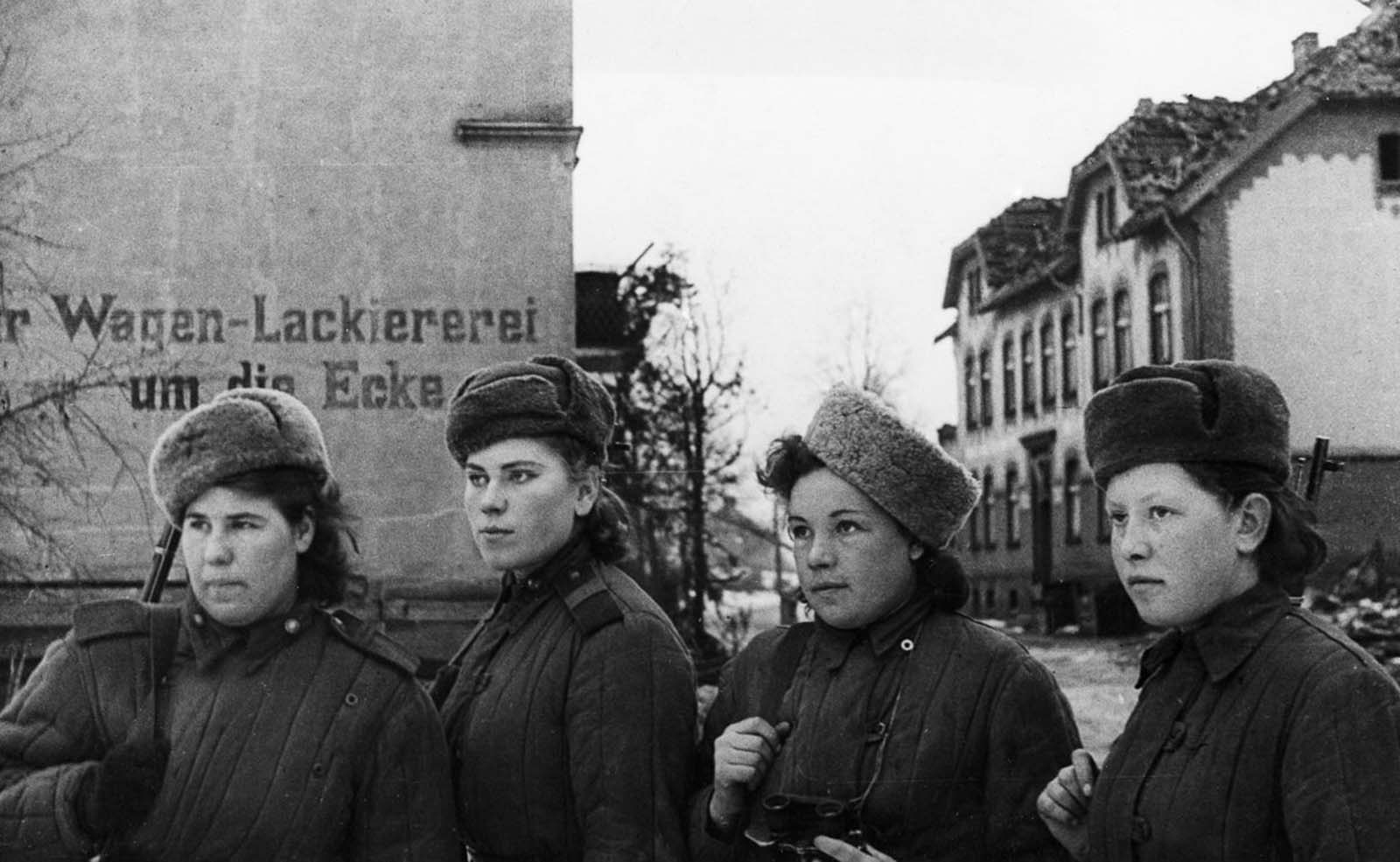 Snipers inspect an East Prussian town recently captured by the Soviets. February, 1945.