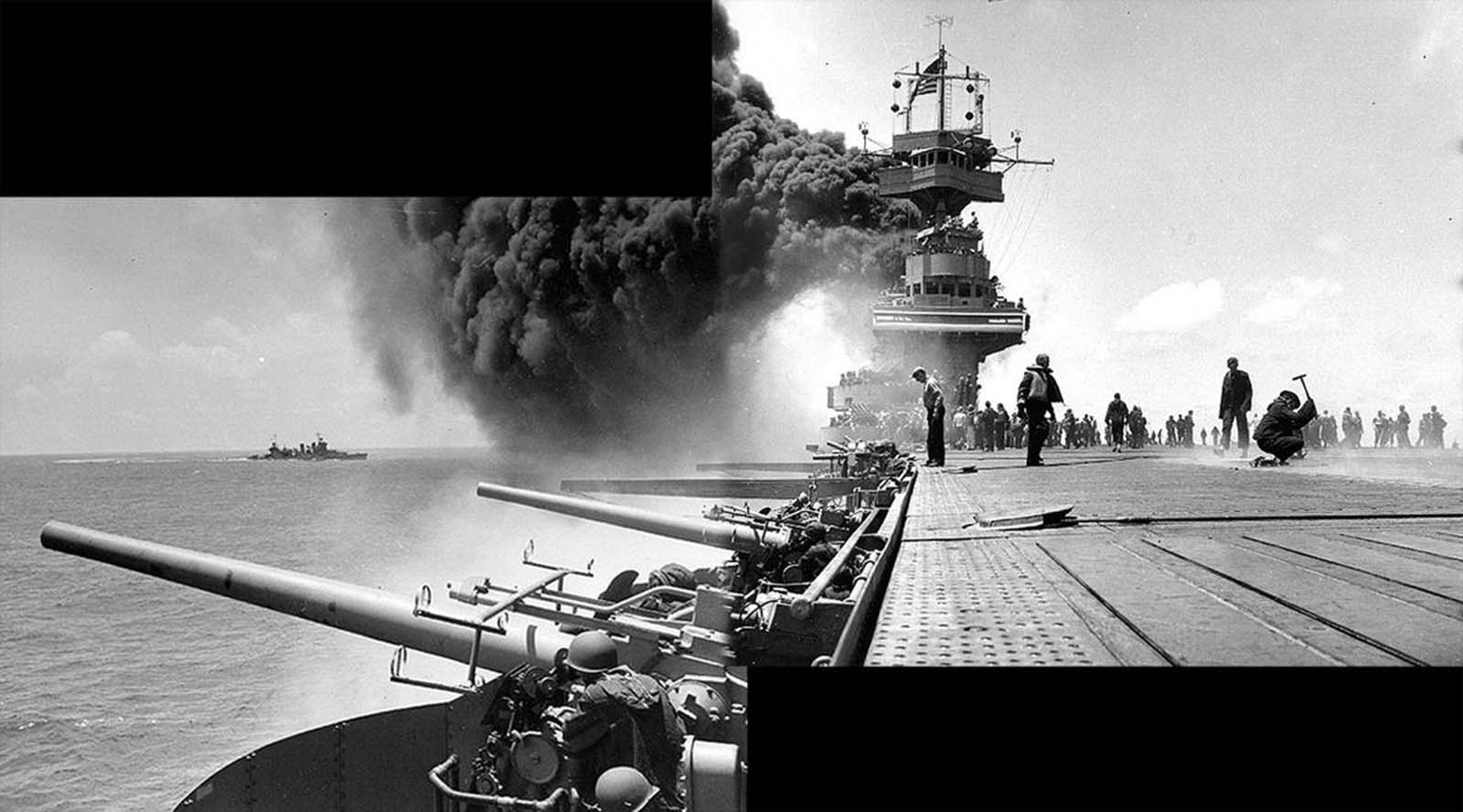 Scene on board USS Yorktown, shortly after she was hit by three Japanese bombs on June 4, 1942. The dense smoke is from fires in her uptakes, caused by a bomb that punctured them and knocked out her boilers. Panorama made from two photographs taken by Photographer 2rd Class William G. Roy from the starboard side of the flight deck, just in front of the forward 5
