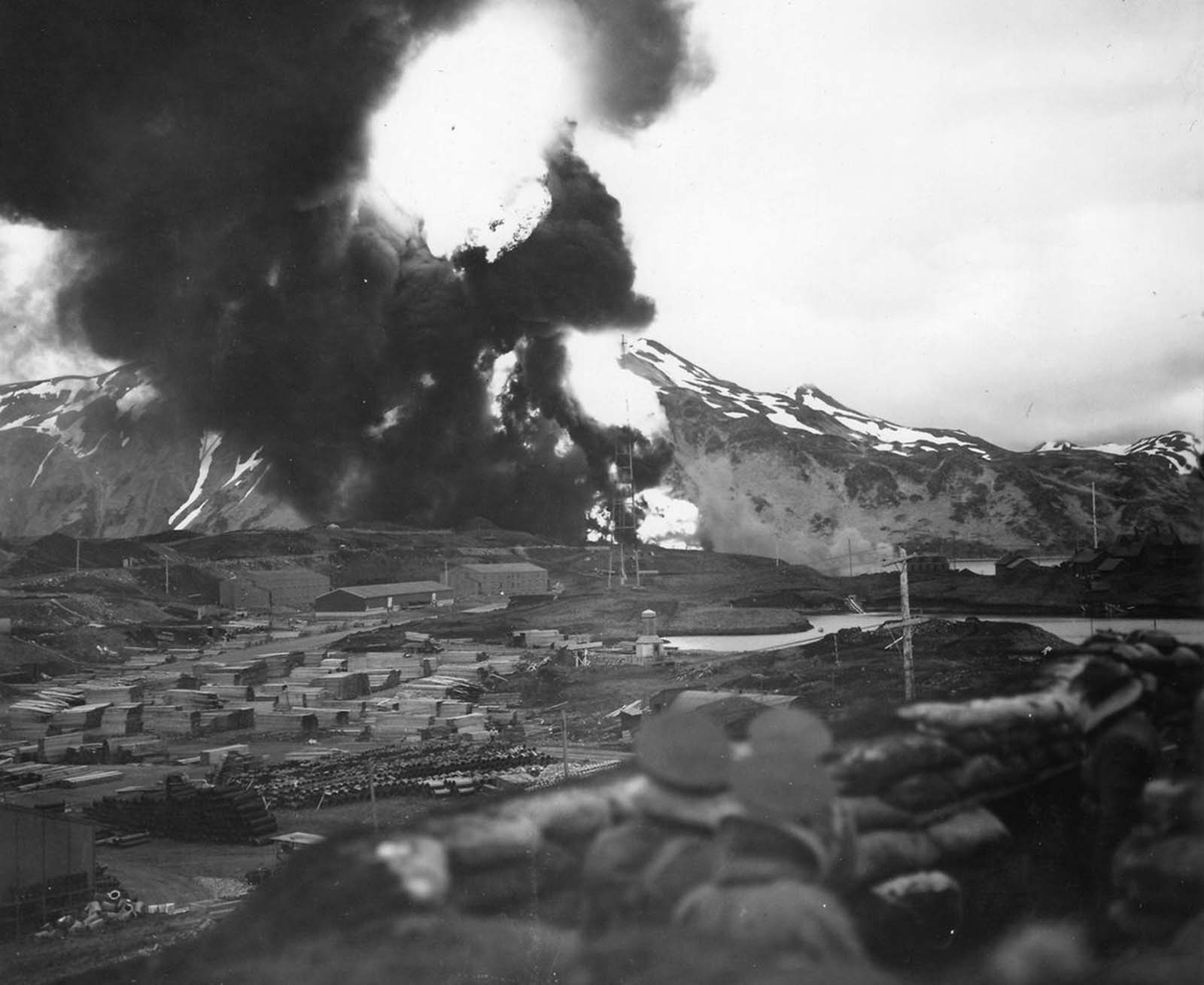 U.S. forces watch a massive fireball rise above Dutch Harbor, Alaska after a Japanese air strike in June of 1942.