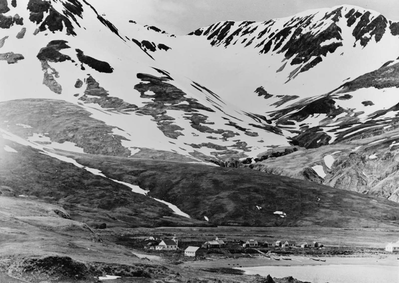 Bleak, mountainous Attu Island in Alaska had a population of only about 46 people prior to the Japanese invasion. On June 6, 1942, a Japanese force of 1,100 soldiers landed, occupying the island. One resident was killed in the invasion, the remaining 45 were shipped to a Japanese prison camp near Otaru, Hokkaido, where sixteen died while in captivity. This is a picture of Attu village situated on Chichagof Harbor.