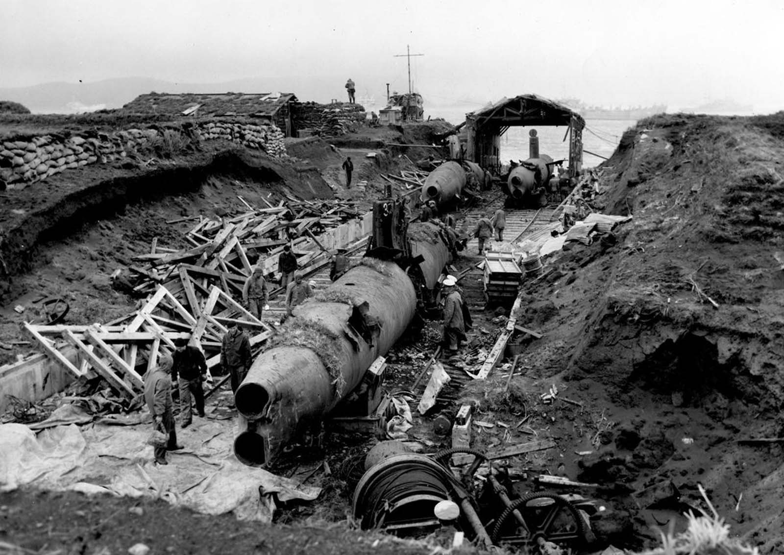 A heavily damaged midget submarine base constructed by occupying Japanese forces on Kiska Island, photo taken sometime in 1943, after Allied forces retook the island.