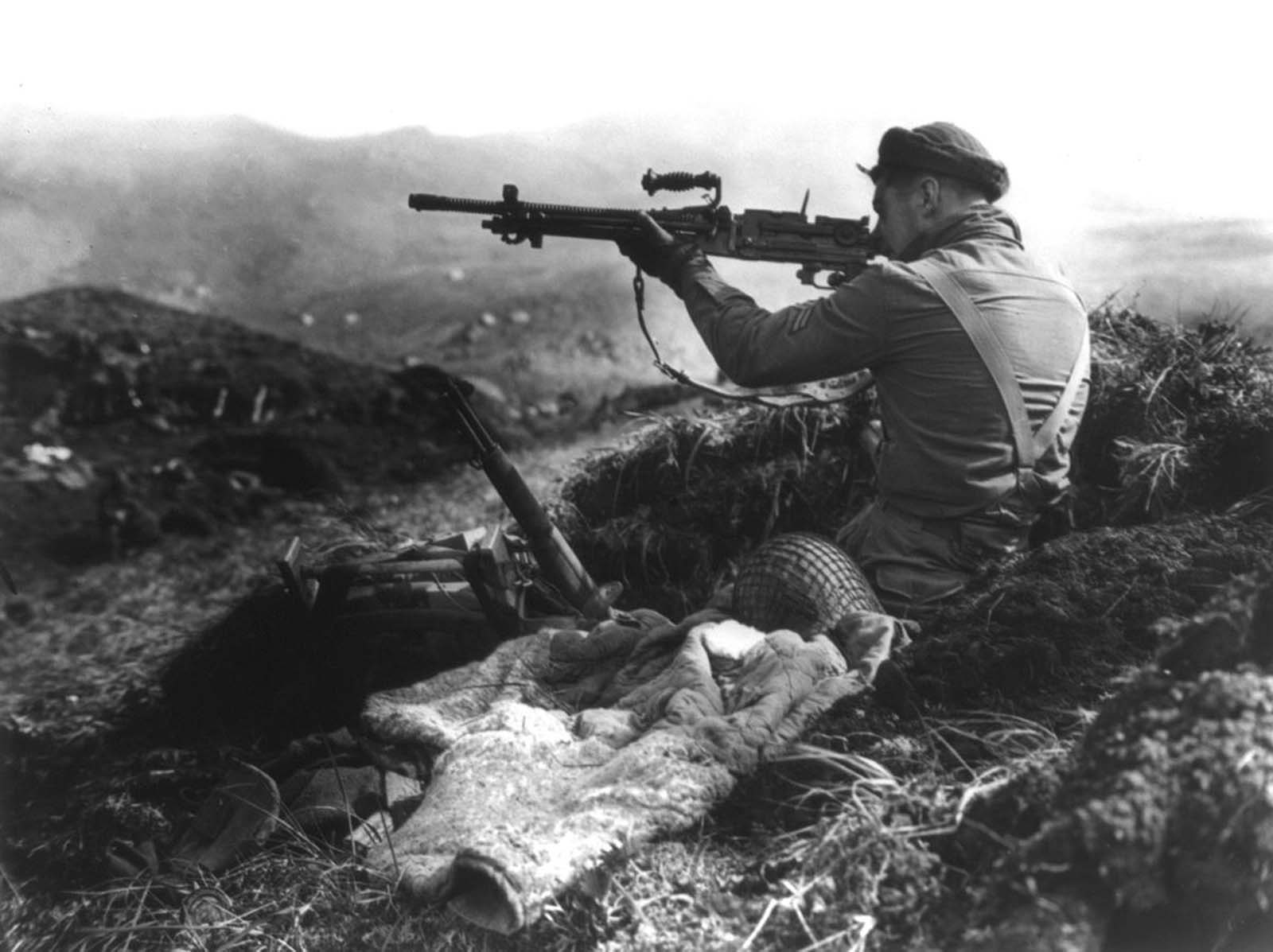 A Canadian member of the joint American-Canadian landing force squints down the sights of a Japanese machine gun found in a trench on Kiska Island, Alaska, on August 16, 1943. After the brutal fighting in the battle to retake Attu Island, U.S. and Canadian forces were prepared for even more of a fight on Kiska. Unknown to the Allies though, the Japanese had evacuated all their troops two weeks earlier. Although the invasion was unopposed, 32 soldiers were killed in friendly-fire incidents, four more by booby traps, and a further 191 were listed as Missing in Action.