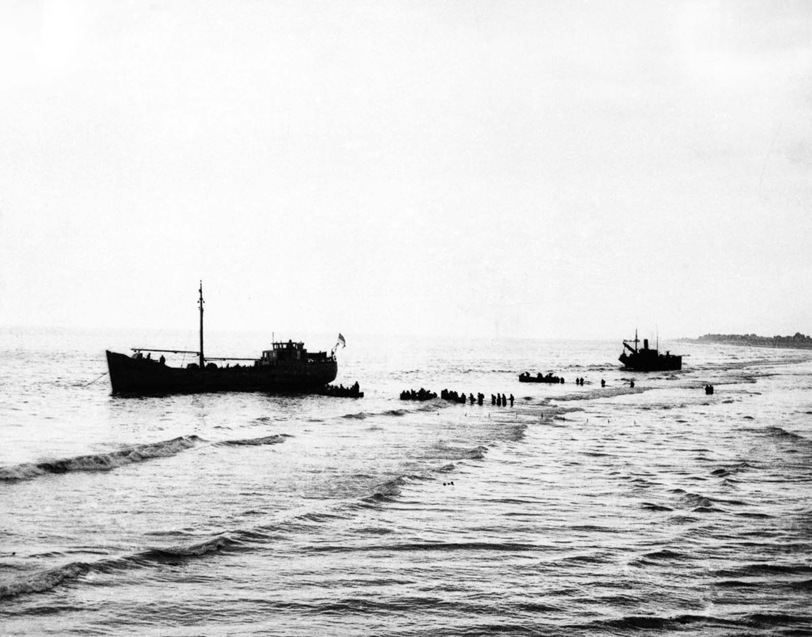 British Expeditionary Forces wade out to one of the 