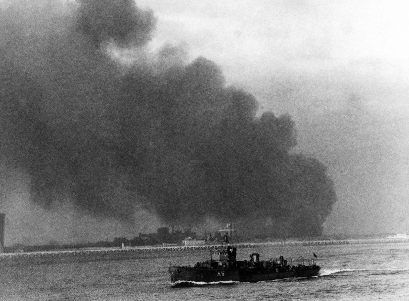 A British destroyer carries evacuees home while Dunkirk burns and the rearguard continues to fight.