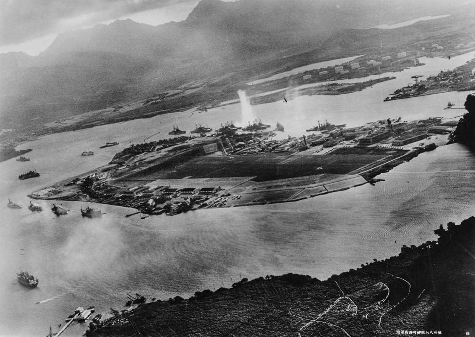 A plume of water erupts as a torpedo strikes the USS West Virginia, anchored in Battleship Row next to Ford Island.