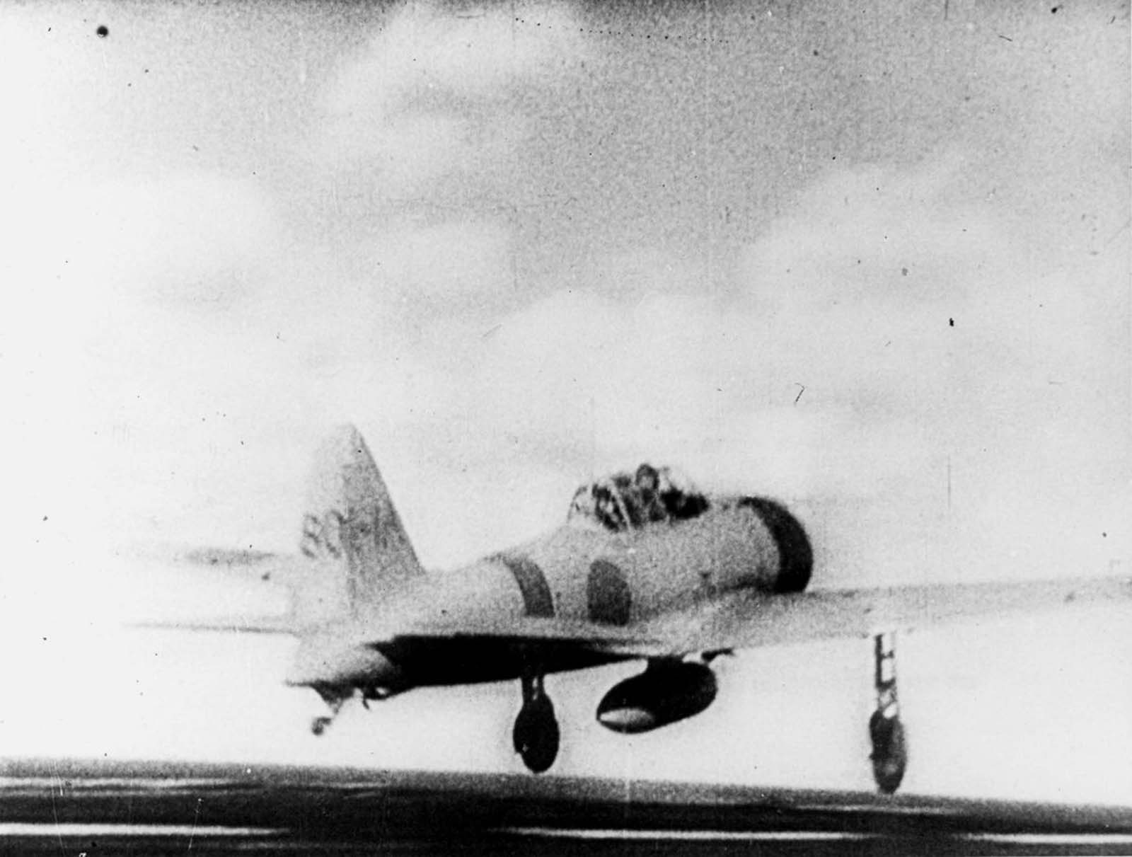 A Zero fighter takes off to join the attack.