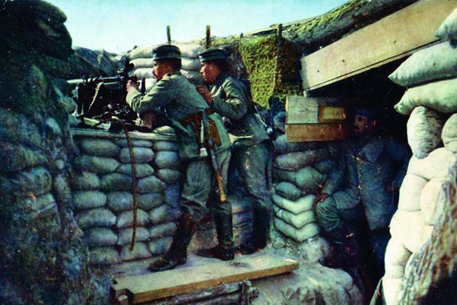 A German soldier posing with a machine gun.