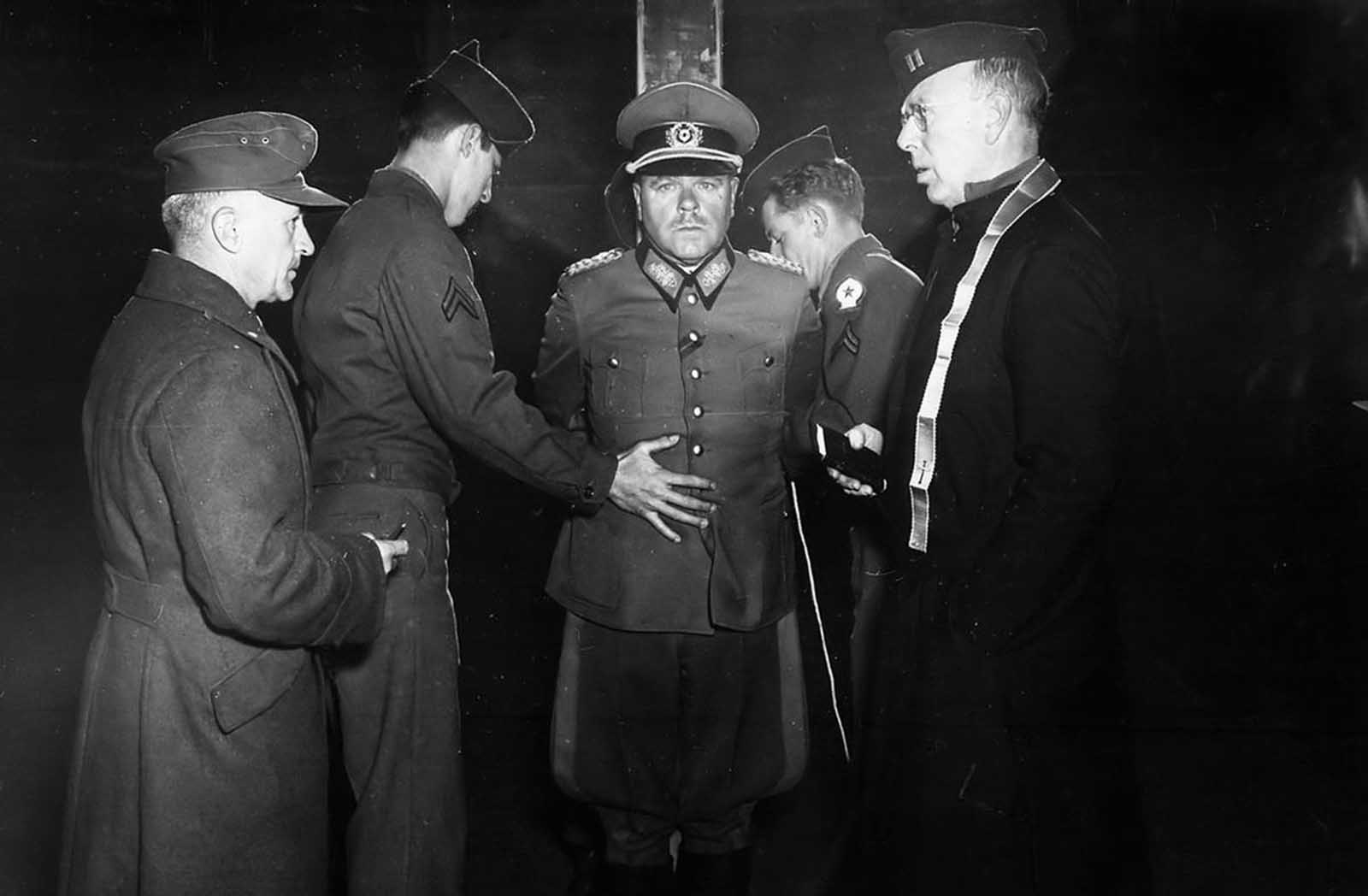 German Wehrmacht General Anton Dostler is tied to a stake before his execution by a firing squad in a stockade in Aversa, Italy, on December 1, 1945. The General, Commander of the 75th Army Corps, was sentenced to death by an United States Military Commission in Rome for having ordered the shooting of 15 unarmed American prisoners of war, in La Spezia, Italy, on March 26, 1944