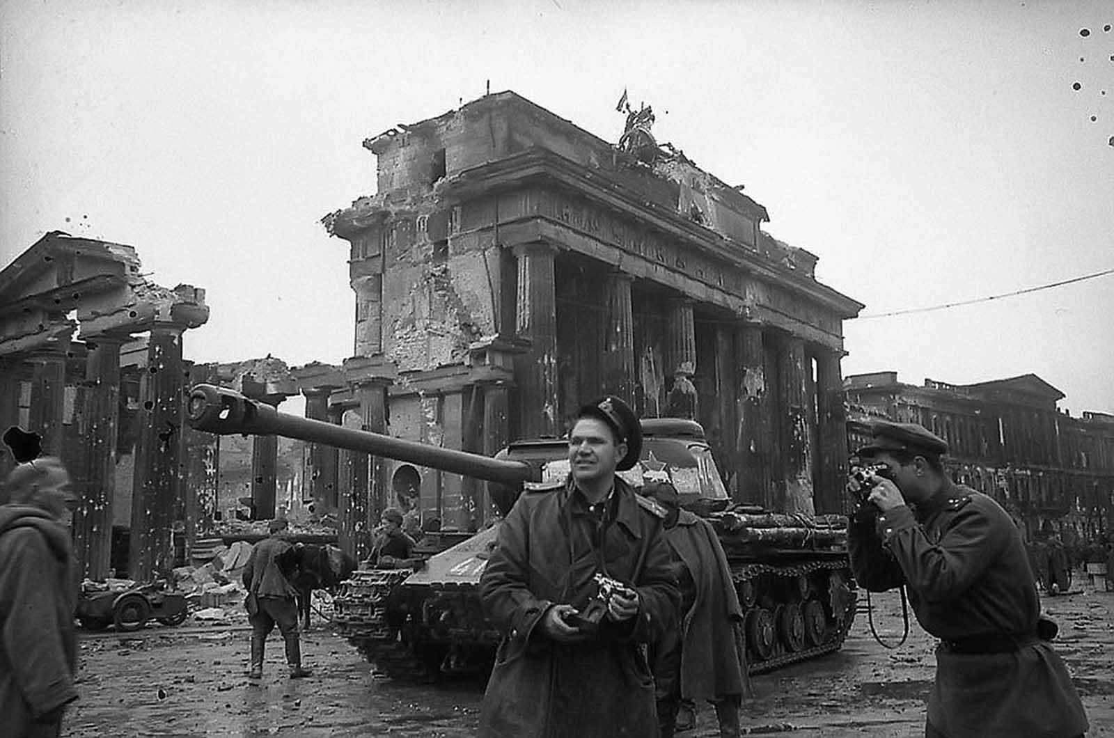 Red Army photographer Yevgeny Khaldei (center) in Berlin with Soviet forces, near the Brandenburg Gate in May of 1945.