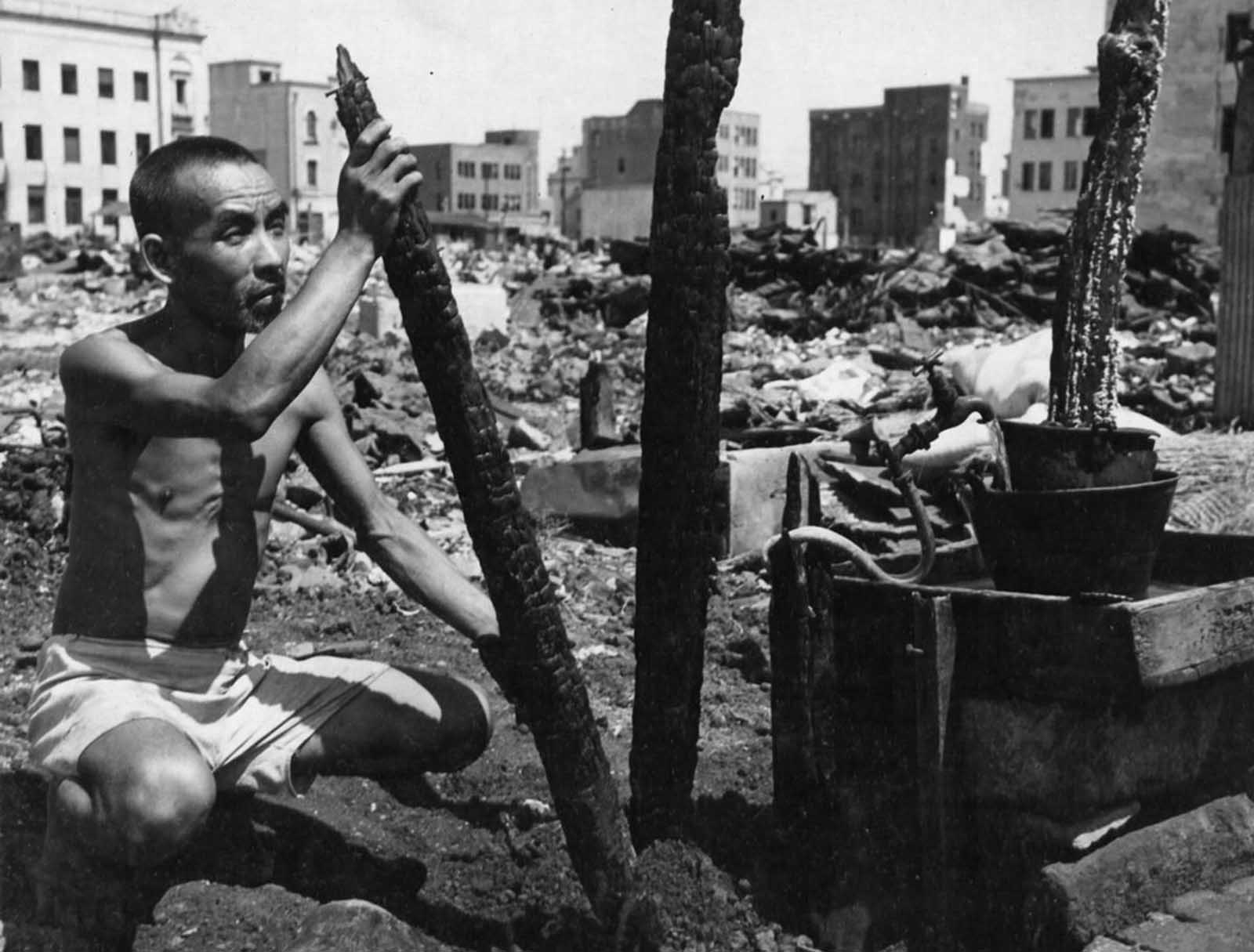 A Japanese man amid the scorched wreckage and rubble that was once his home in Yokohama, Japan.