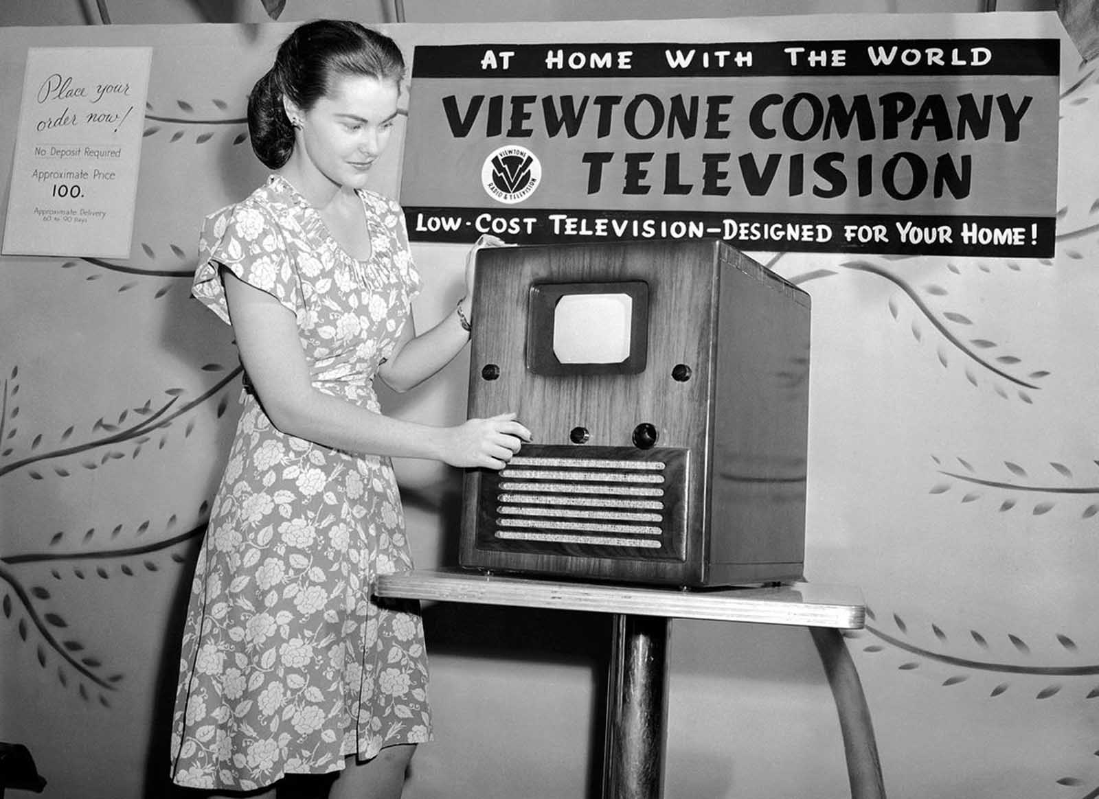 This television set, retailing for $100, is reportedly the first moderately priced receiver manufactured in quantity. Rose Clare Leonard watches the screen, which reproduces a 5x7 image, as she tunes in at the first public post-war showing at a New York department store, on August 24, 1945. Although television was invented prior to World War II, the war prevented mass production. Soon after the war, sales and production picked up, and by 1948, regular commercial network programming had begun.