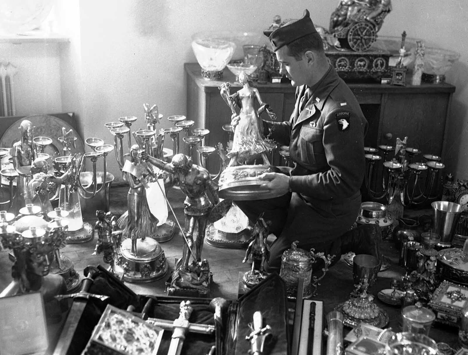A U.S. soldier examines a solid gold statue, part of Hermann Goering's private loot, found by the 7th U.S. Army in a mountainside cave near Schonau am Konigssee, Germany, on May 25, 1945. The secret cave, the second found to date, also contained stolen priceless paintings from all over Europe.