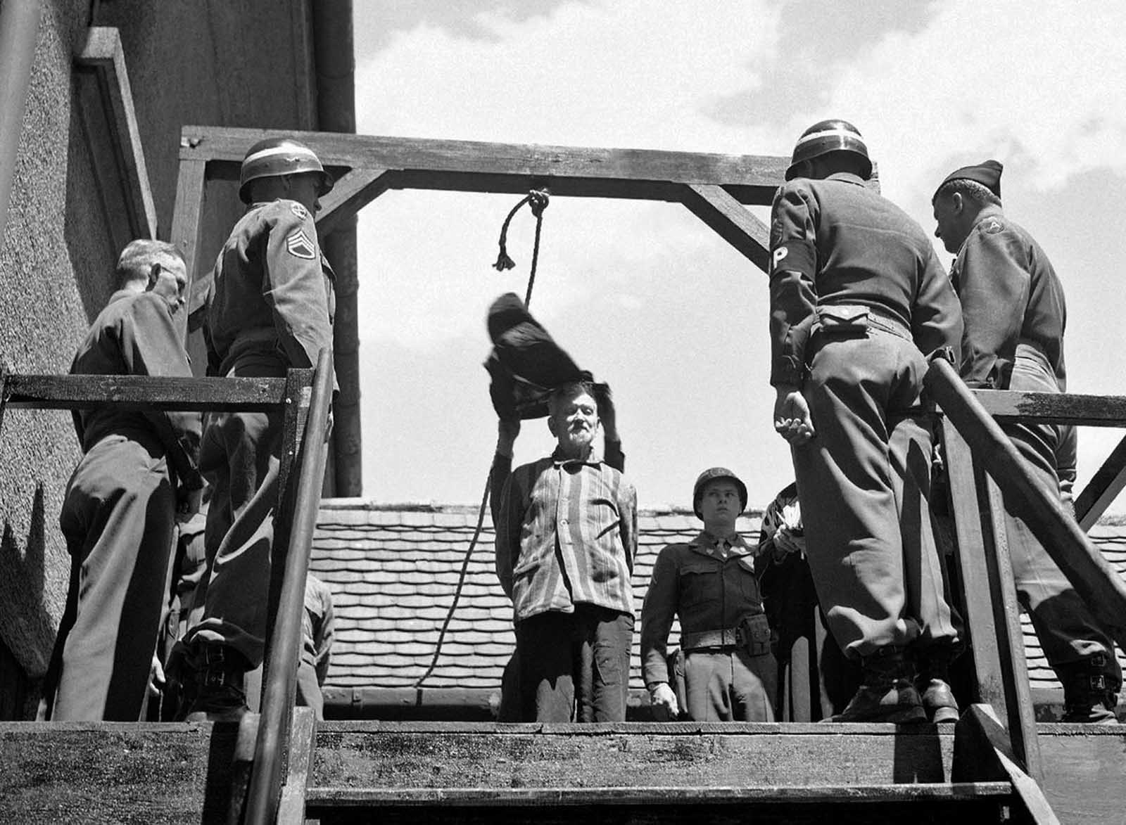 U.S. military authorities prepare to hang Dr. Klaus Karl Schilling, 74, at Landsberg, Germany, on May 28, 1946. In a Dachau war crimes trial he was convicted of using 1,200 concentration camp prisoners for malaria experimentation. Thirty died directly from the inoculations and 300 to 400 died later from complications of the disease. His experiments, all with unwilling subjects, began in 1942.