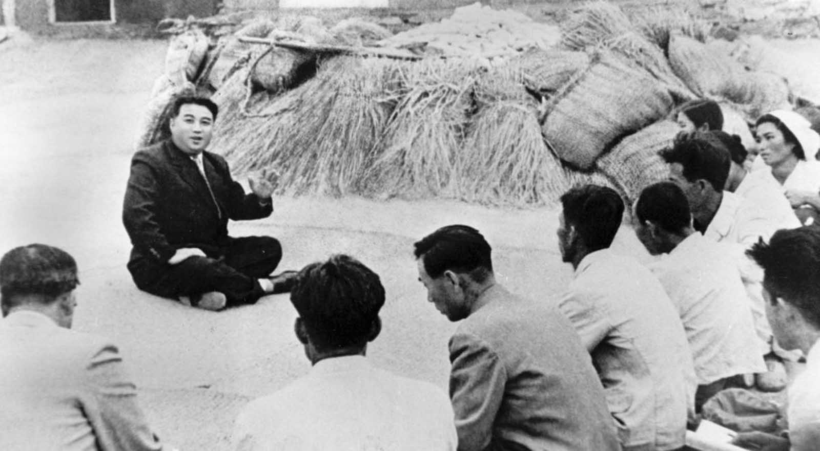 In this October 1945 photo from North Korea's official Korean Central News Agency, communist leader Kim Il Sung chats with a farmer from Qingshanli, Kangso County, South Pyongyang in North Korea.