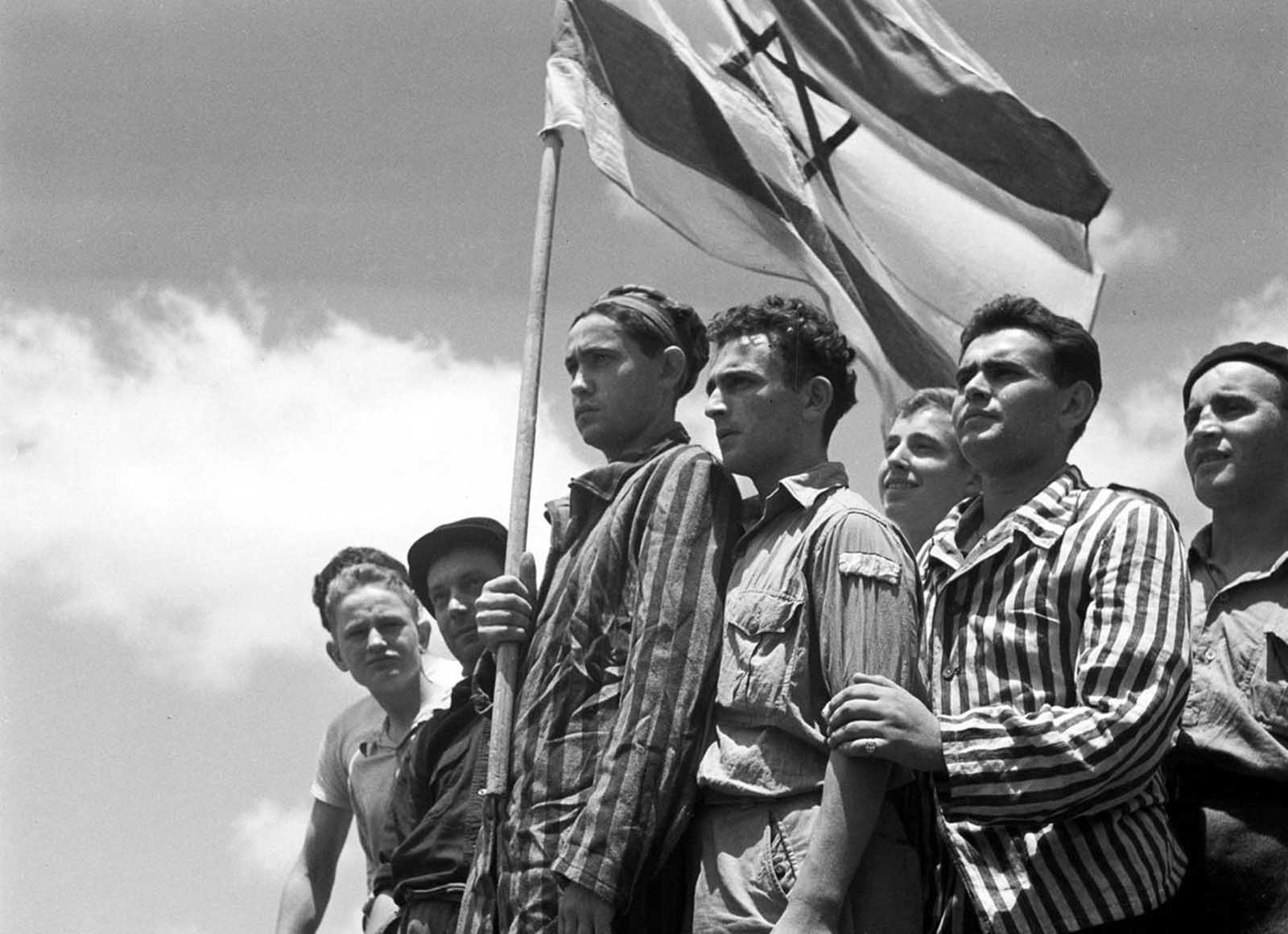 Jewish survivors of the Buchenwald Nazi concentration camp, some still in their camp clothing, stand on the deck of the refugee immigration ship Mataroa, on July 15, 1945 at Haifa port, during the British Mandate of Palestine, in what would later become the State of Israel. During World War II, millions of Jews were fleeing Germany and its occupied territories, many attempting to enter the British Mandate of Palestine, despite tight restrictions on Jewish immigration established by the British in 1939. Many of these would-be immigrants were caught and rounded up into detention camps. In 1947, Britain announced plans to withdraw from the territory, and the United Nations approved the Partition Plan for Palestine, establishing a Jewish and a Palestinian state in the country. On May 14, 1948, Israel declared independence and was immediately attacked by neighboring Arab states, beginning the Arab-Israeli conflict which continues to this day.